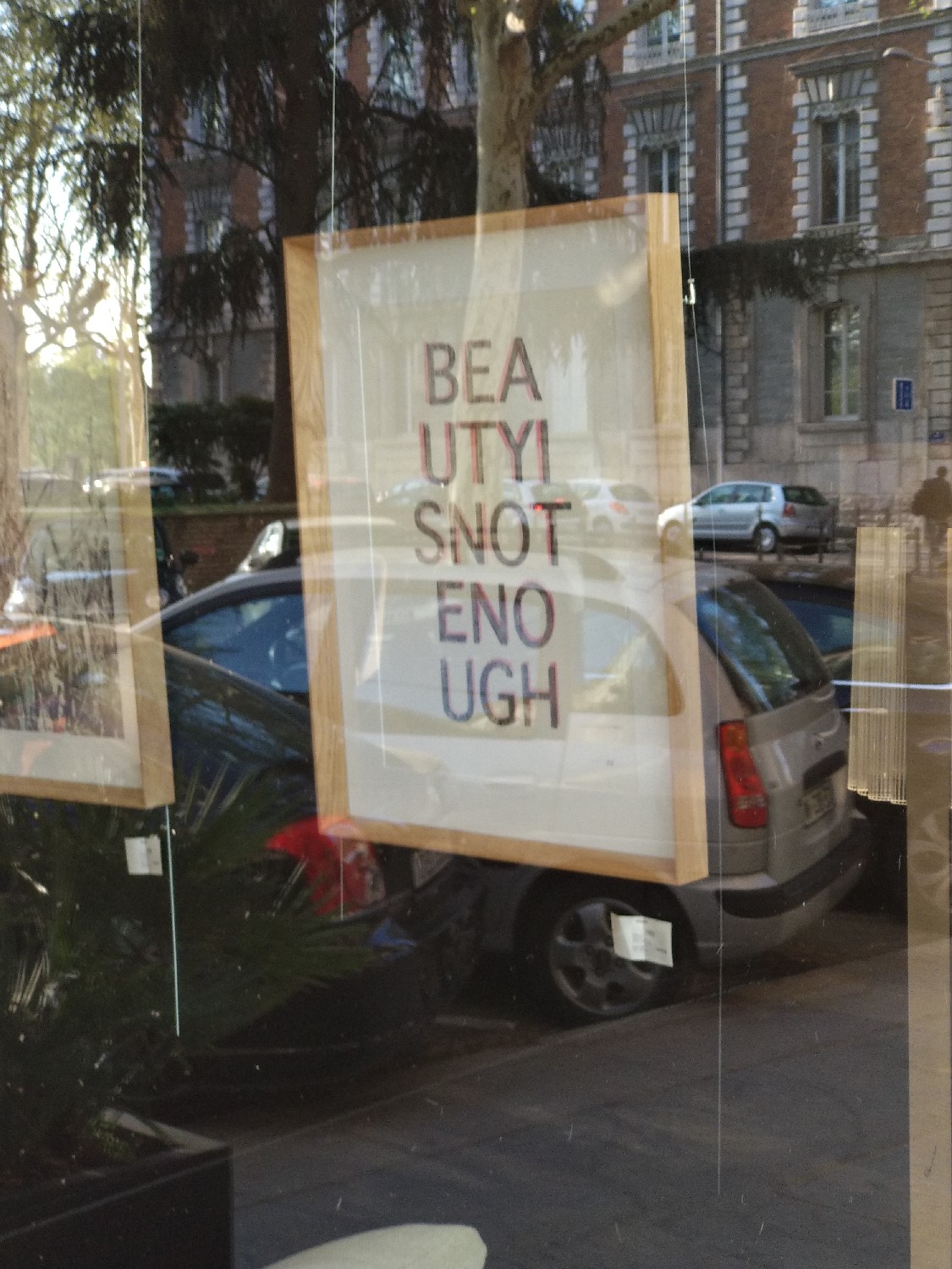 Seen through the storefront of a fancy furniture store. Ugh. r