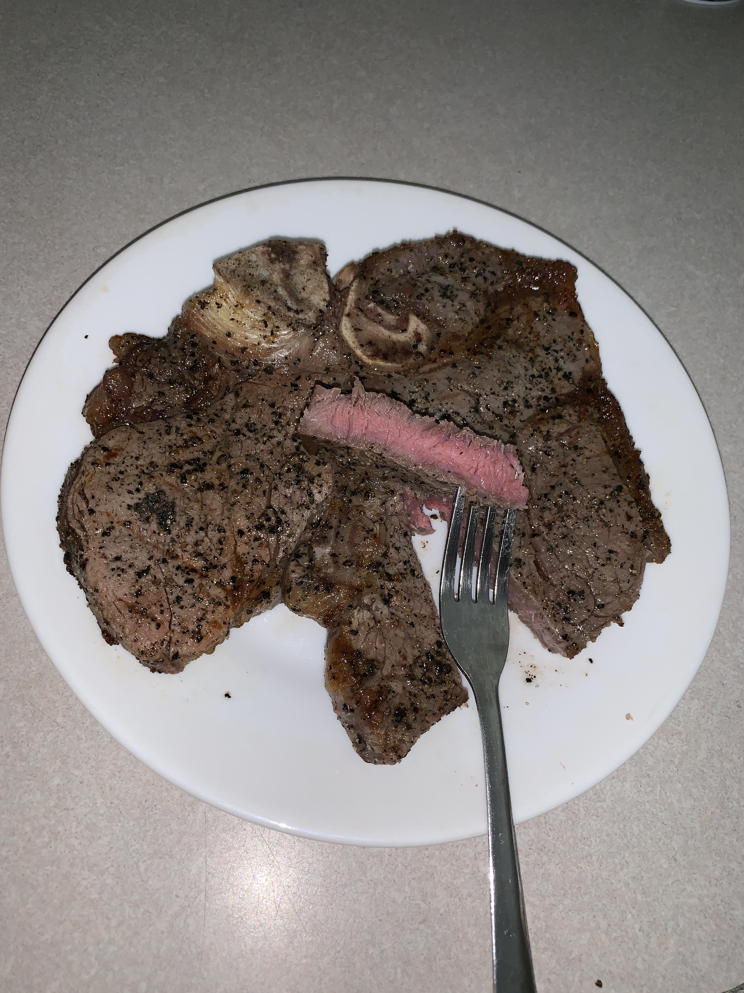 Porterhouse made on a charcoal grill. r/steak
