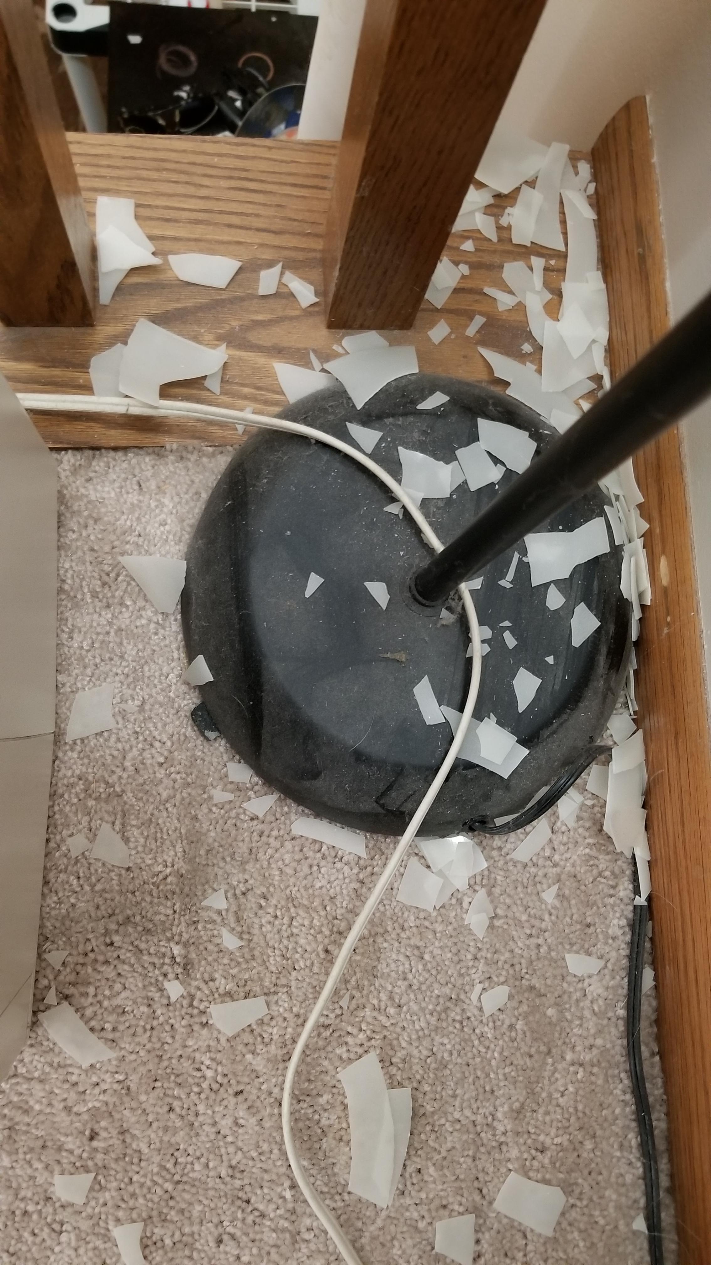 Plastic lamp shade became brittle over time. It touched the wall when I