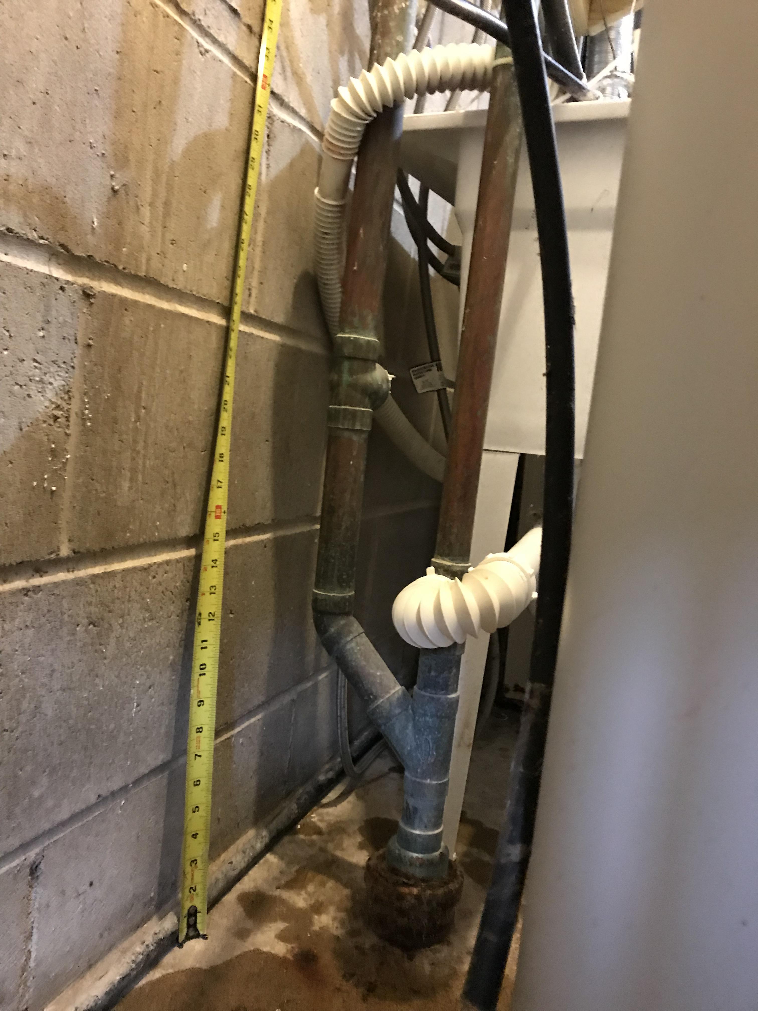 New old house. Drain backing up. Right pipe is vent to roof with util