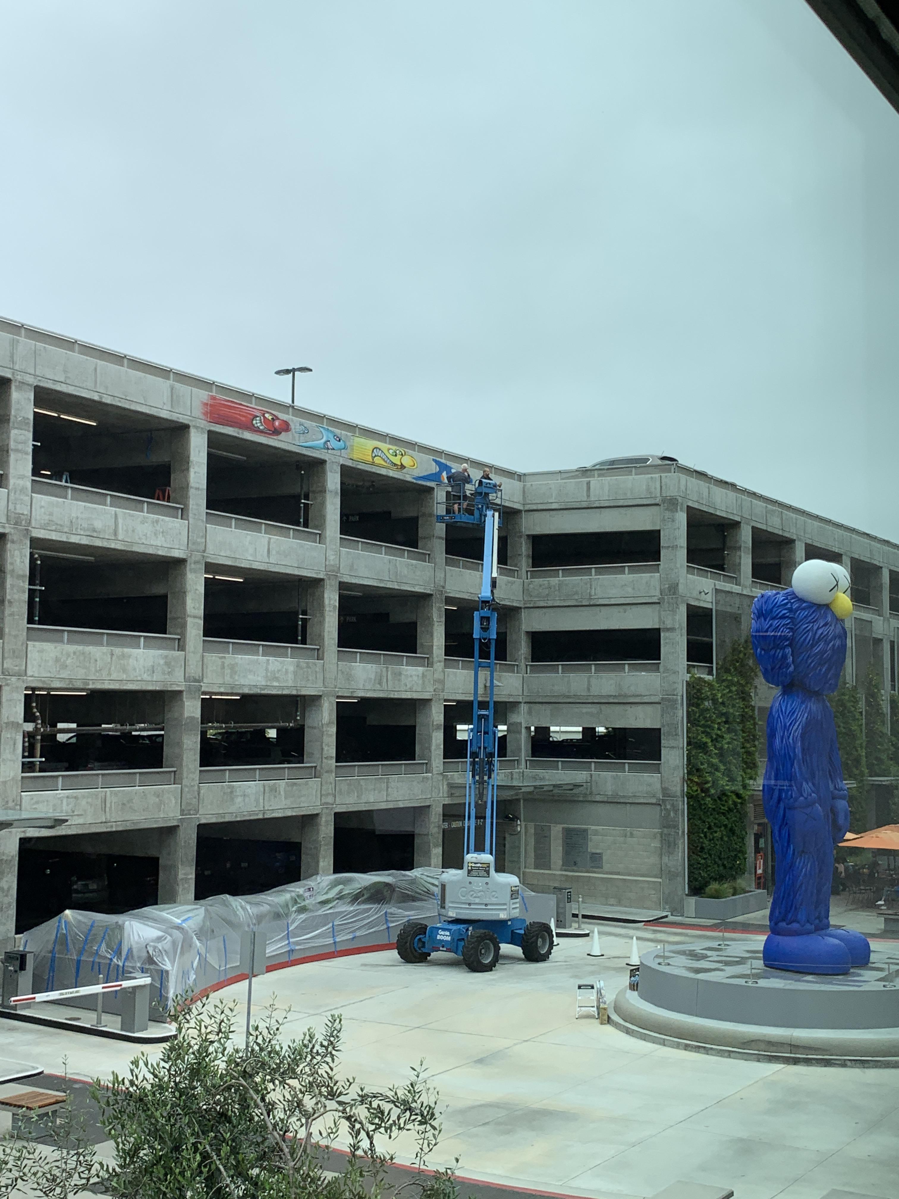 Kenny Scharf currently paining a mural behind the BFF in Playa Vista