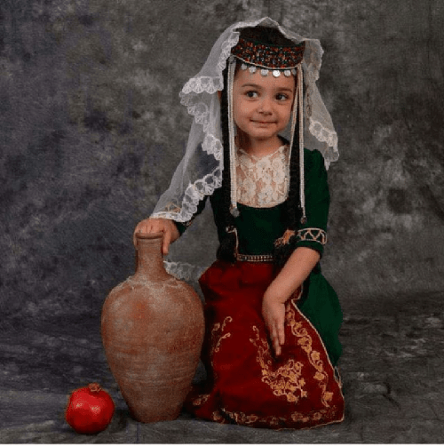 A little Armenian girl in traditional clothing taraz. Good morning r