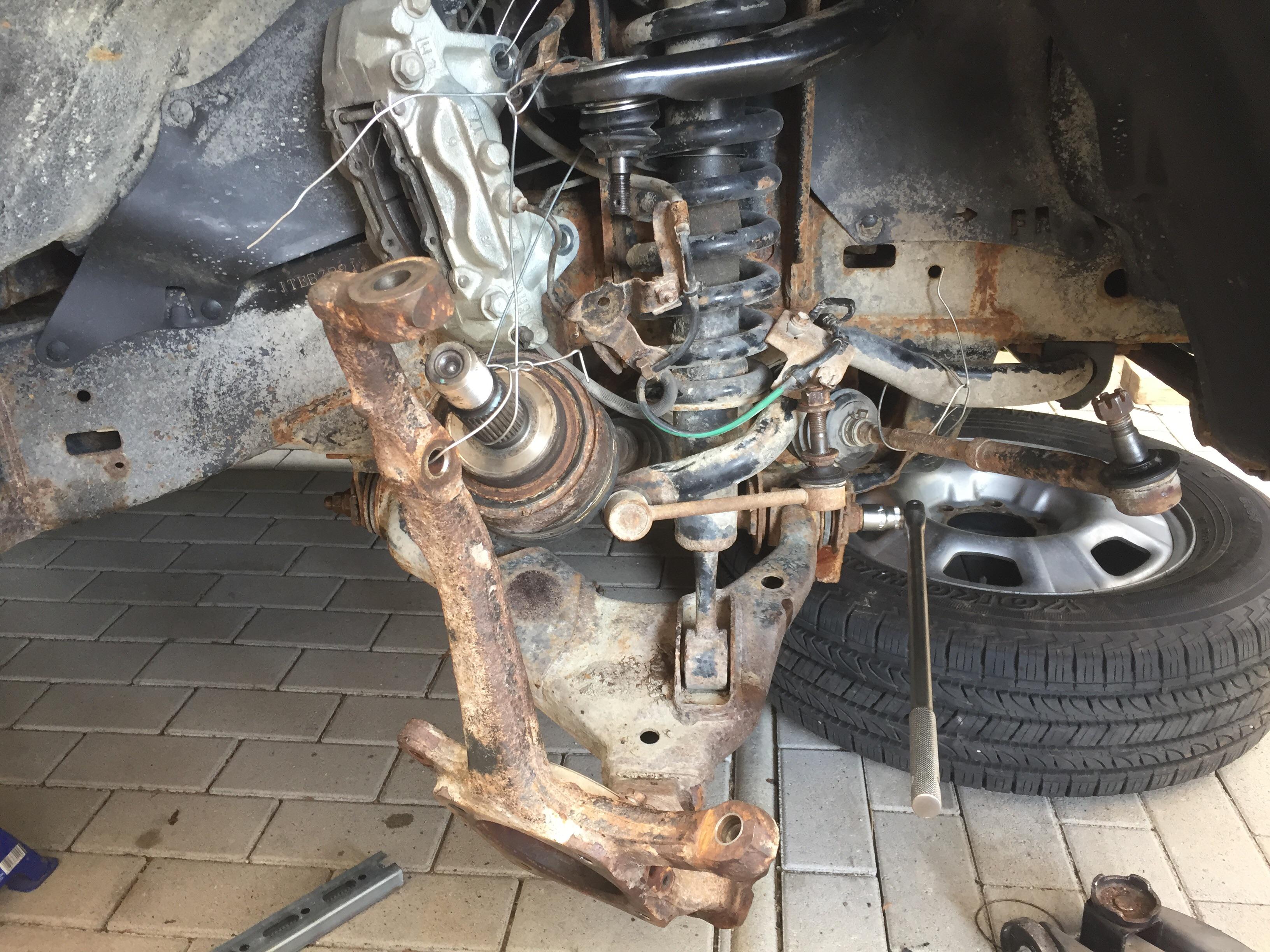 a slightly dismantled front right side... trying to get these two bolts