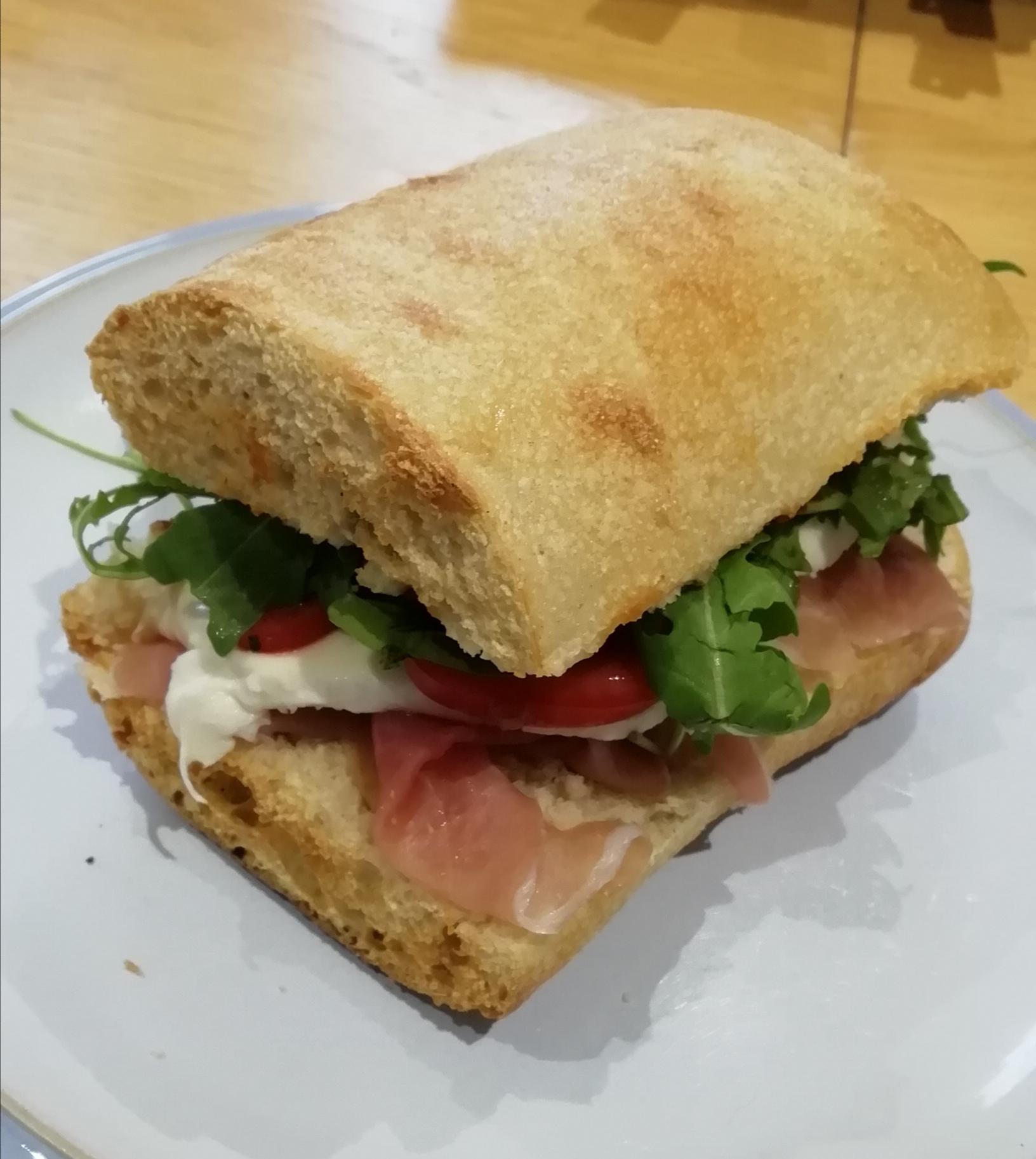 Prosciutto, mozzarella, tomato, rocket (arugula) and red pesto in
