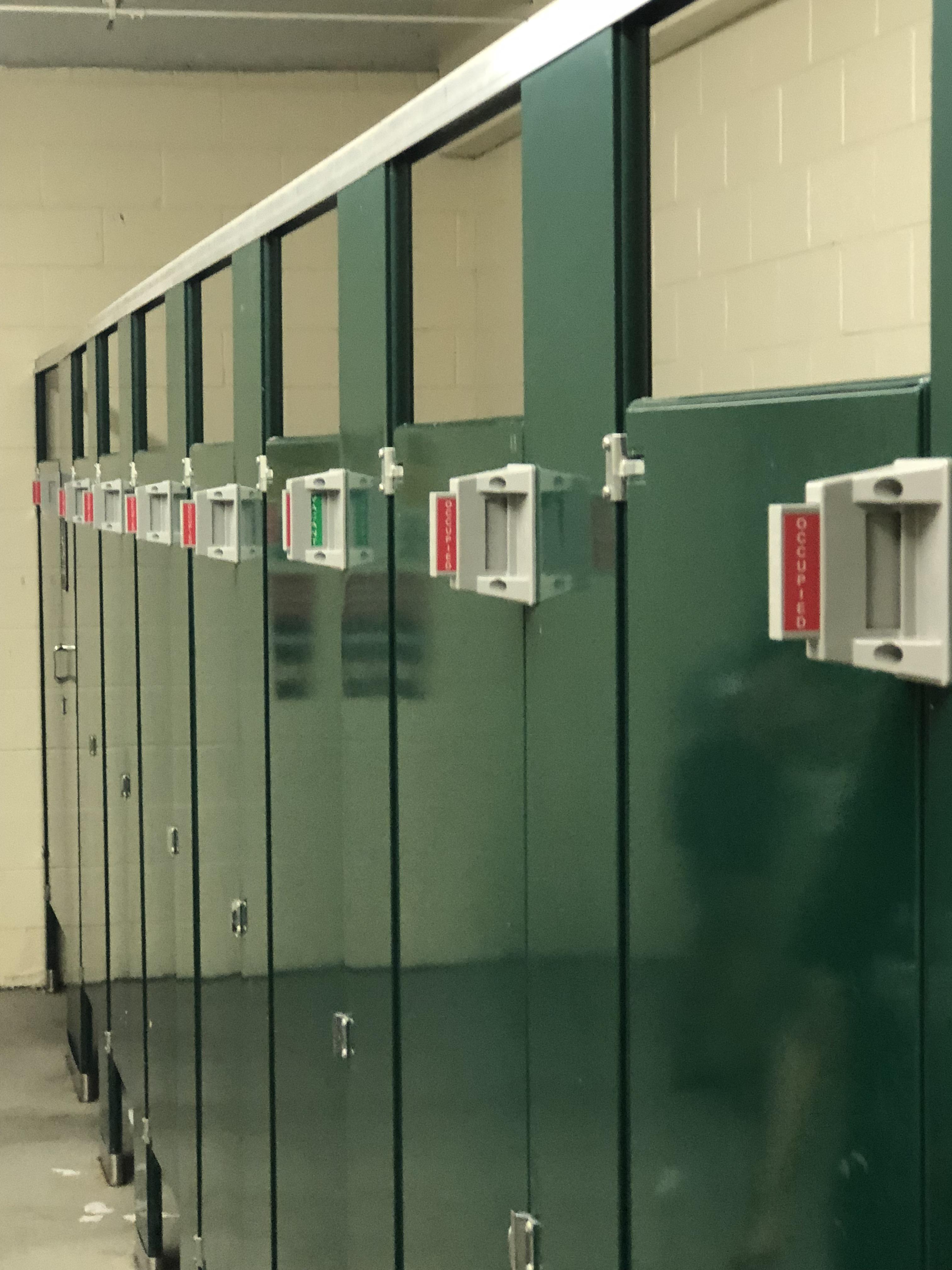 These bathroom stalls at a busy amphitheater that show which ones are