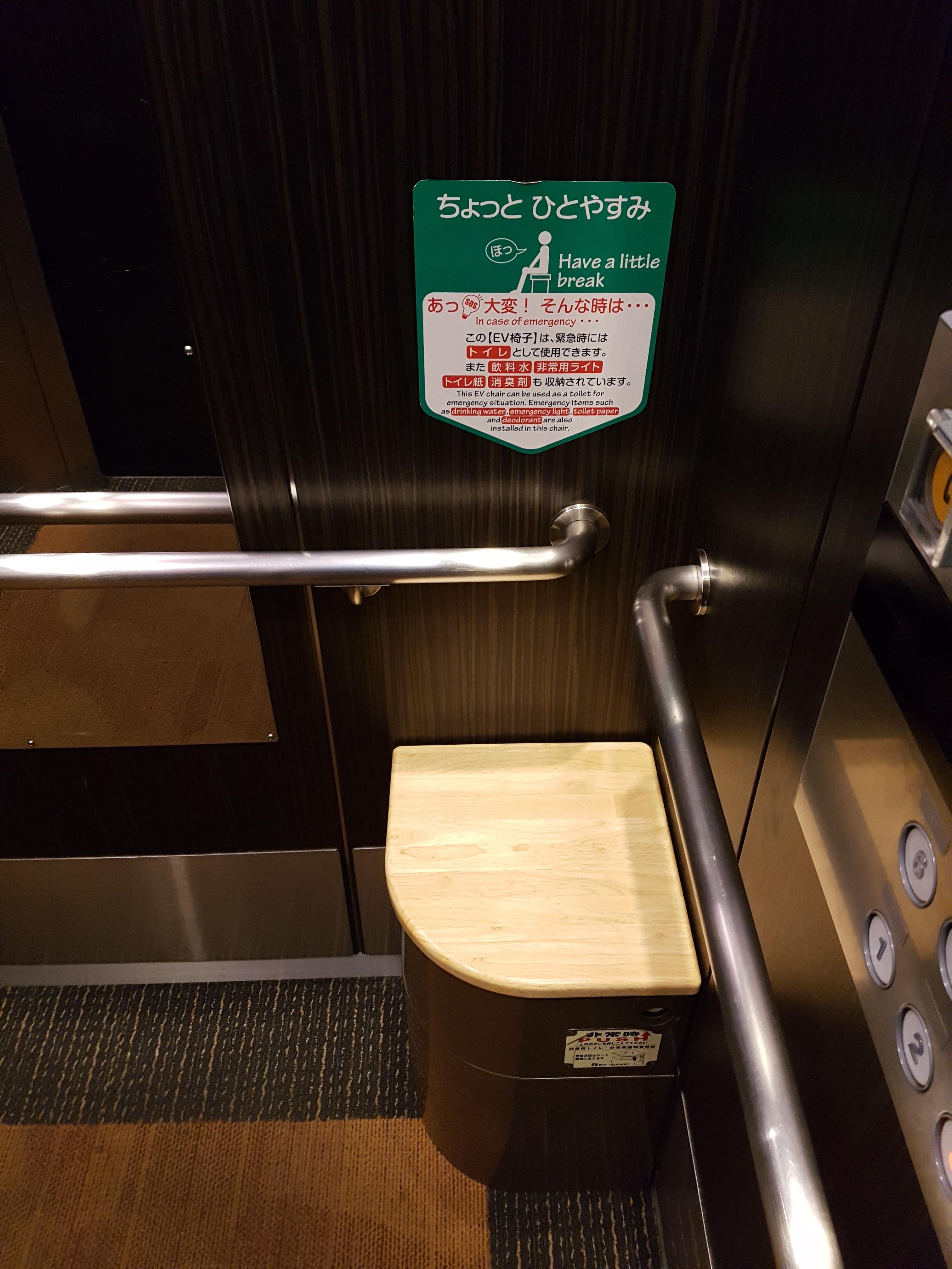 Chair in elevator that doubles as a toilet in case youre trapped during