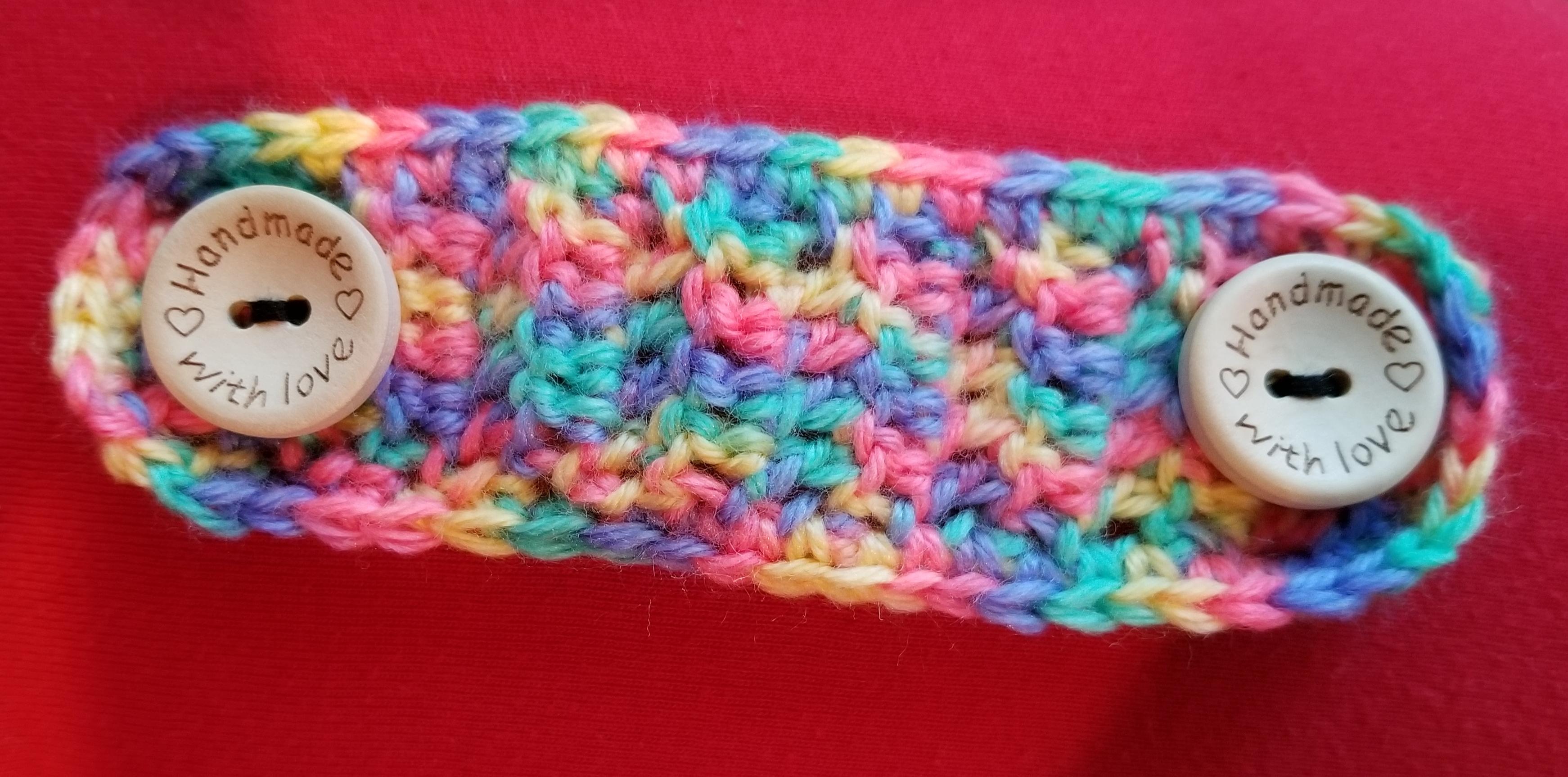 So in love with the buttons I got for my scrap yarn ear savers! r/crochet