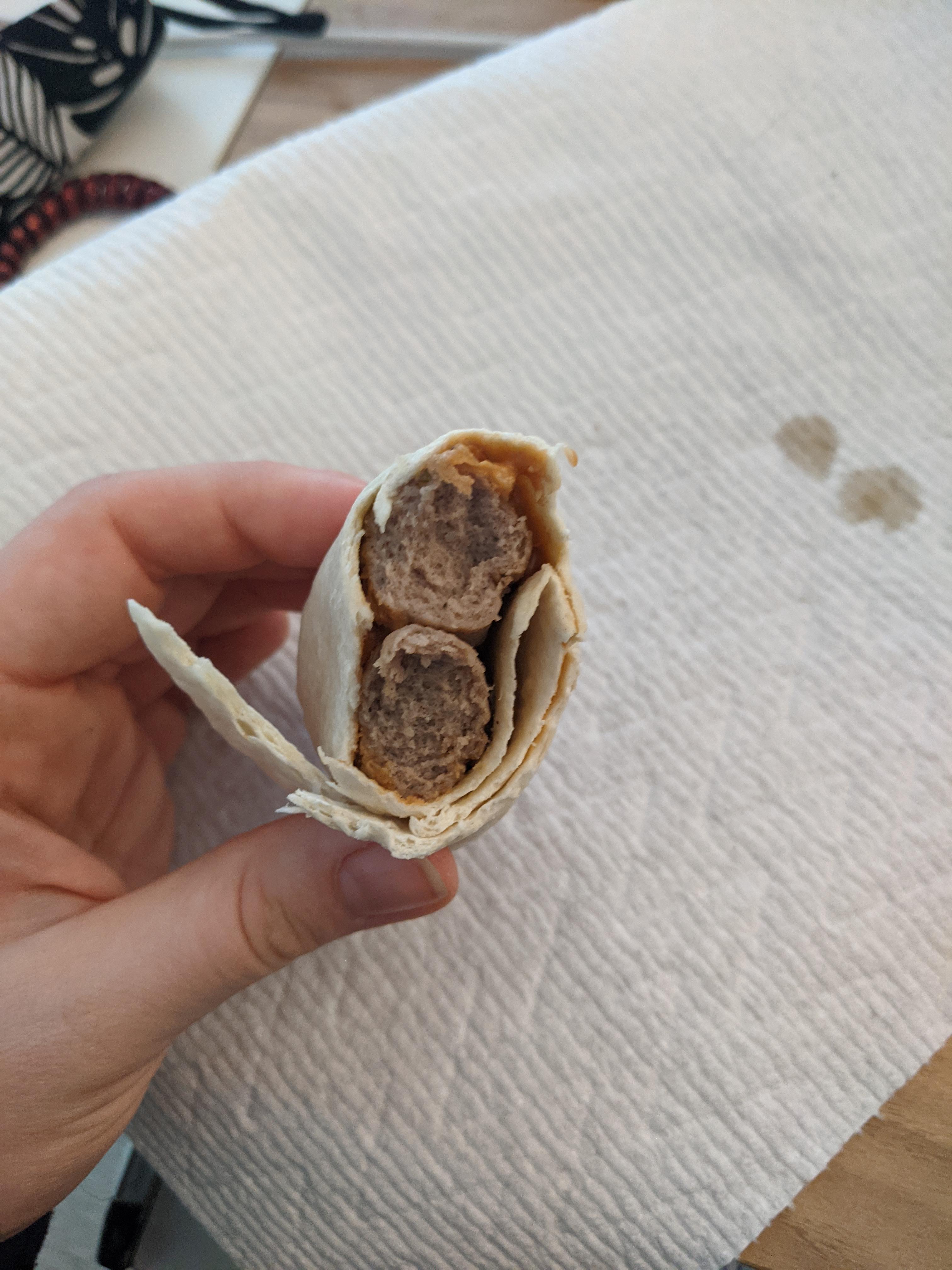 Microwaved breakfast sausage with peanut butter and syrup in half a