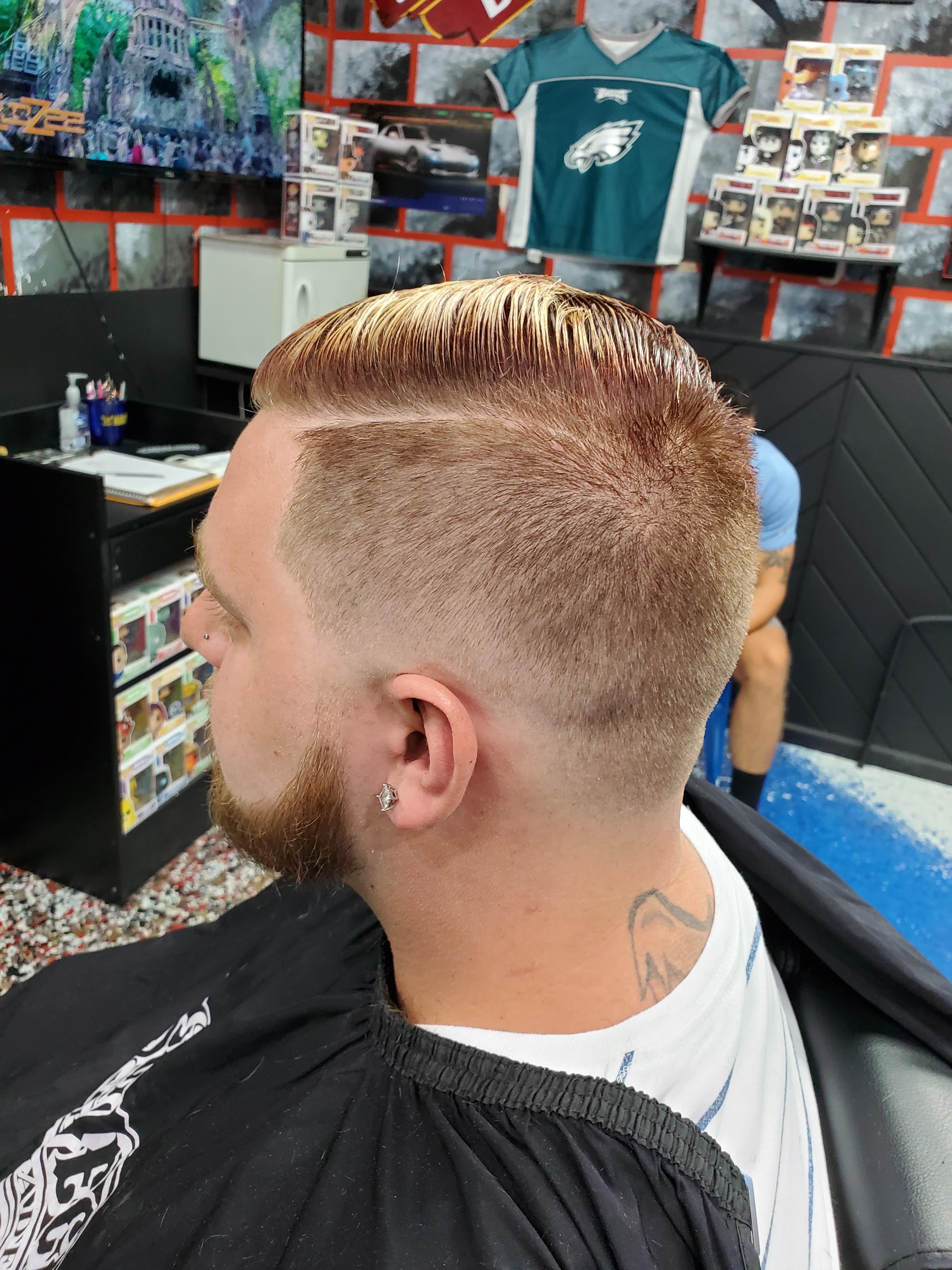 Just a low skin fade with a beard line up. Done with black and gold