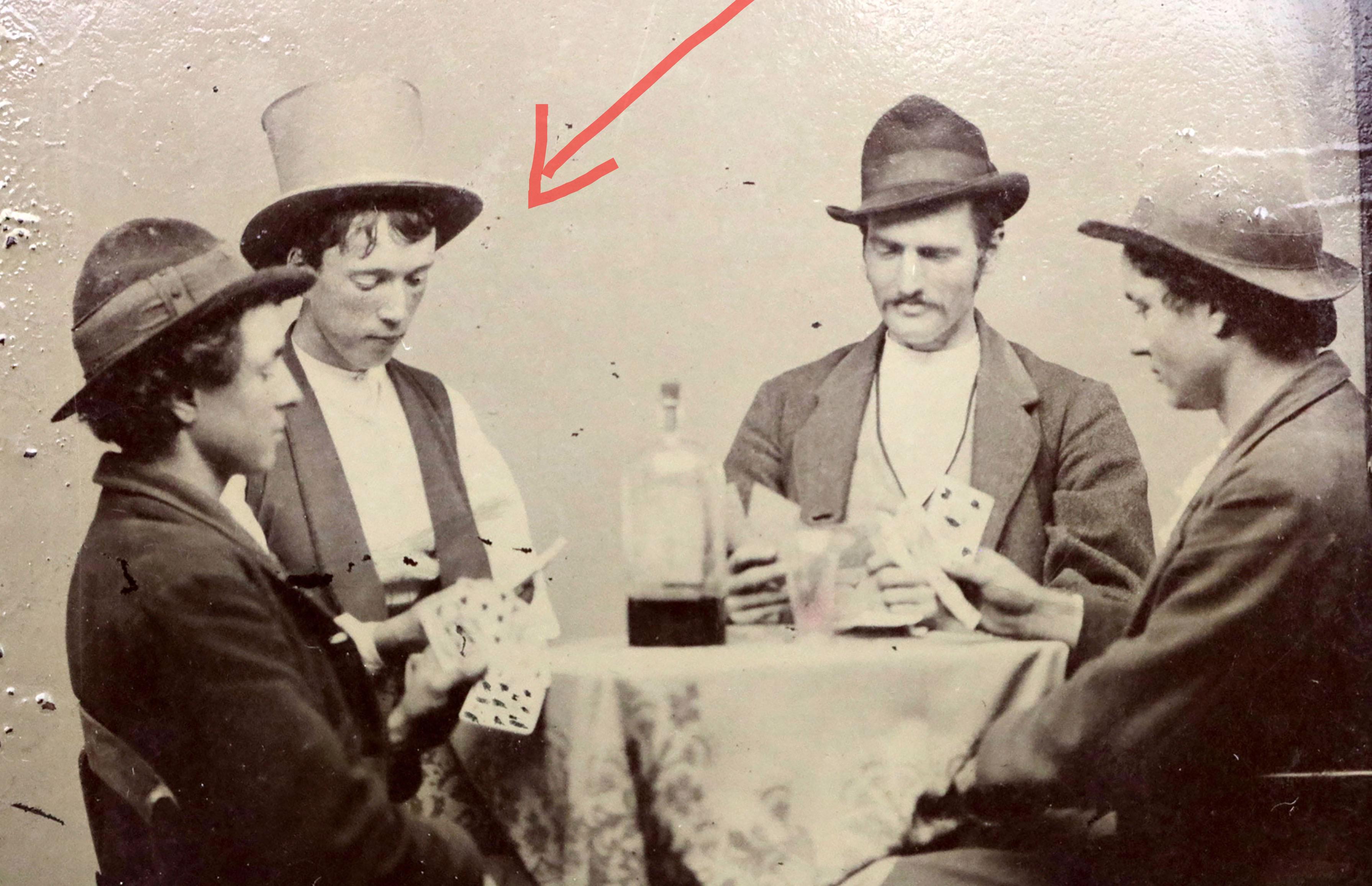 BILLY the Kid plays cards with his gang in a 1877 photo — only the