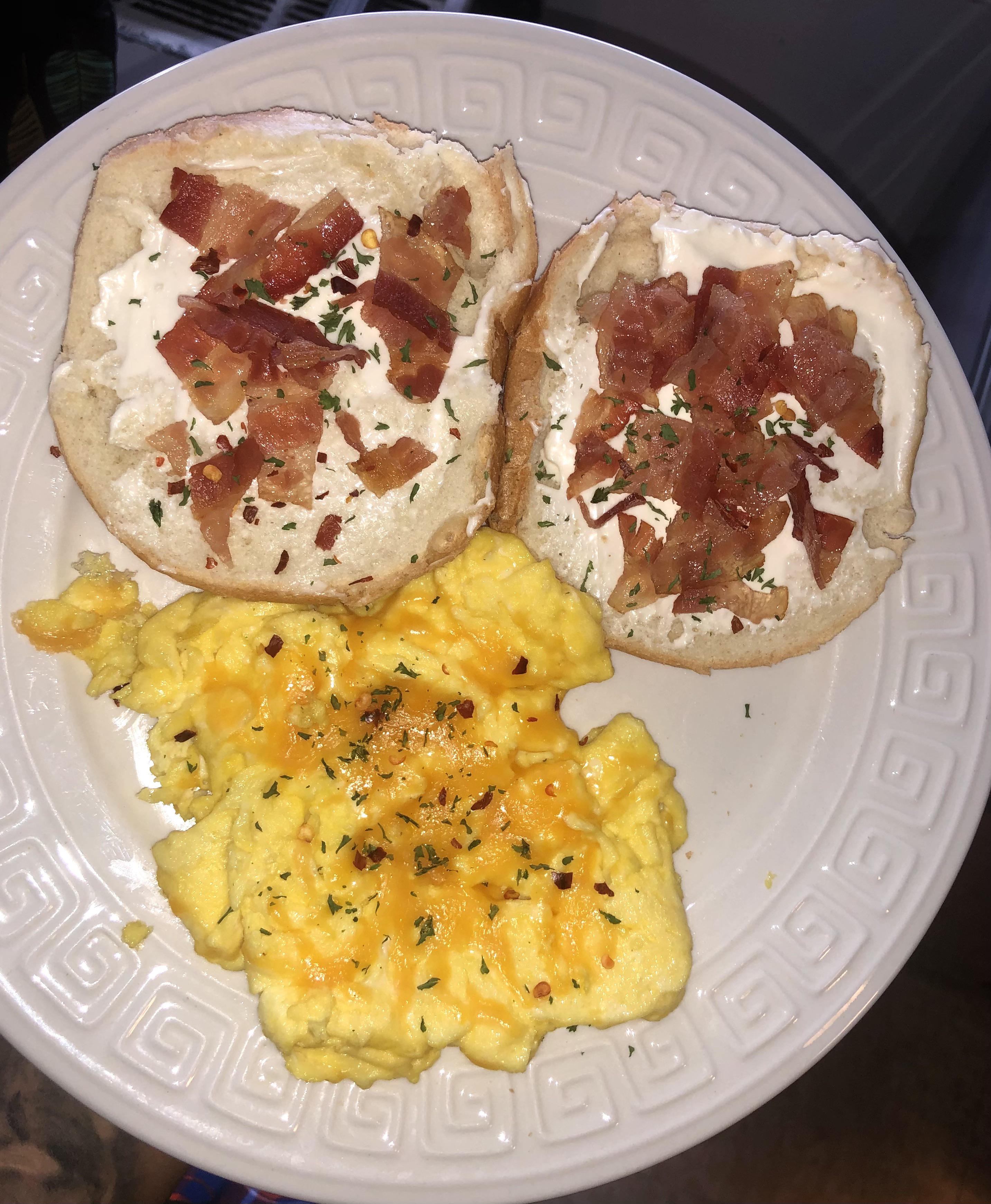 Bacon, cream cheese bagel, scrambled eggs with chilli pepper and parsley. r/shittyfoodporn