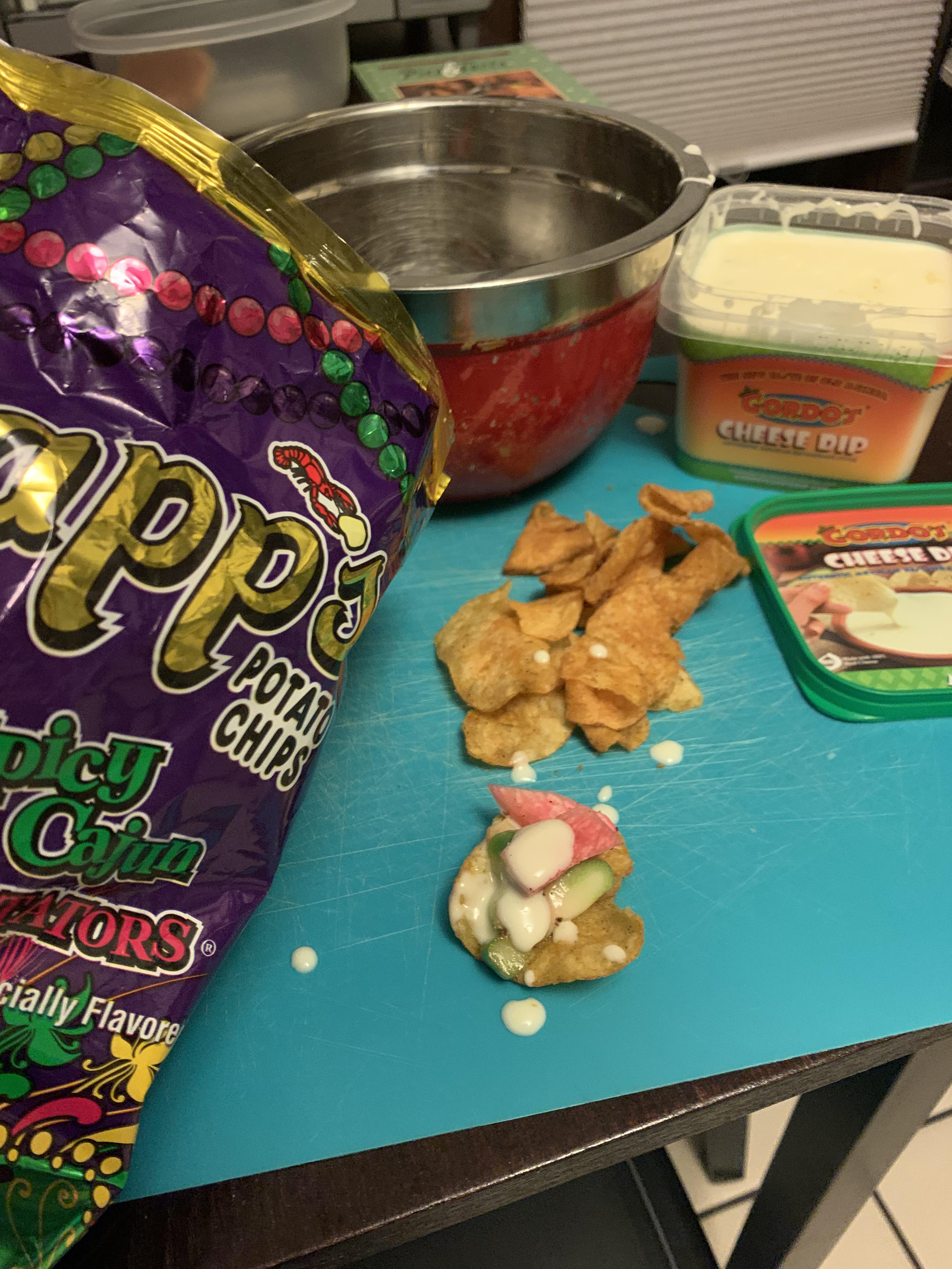 Spicy Cajun Crawtators chips w/ jalapeño cheese dip, radish, and