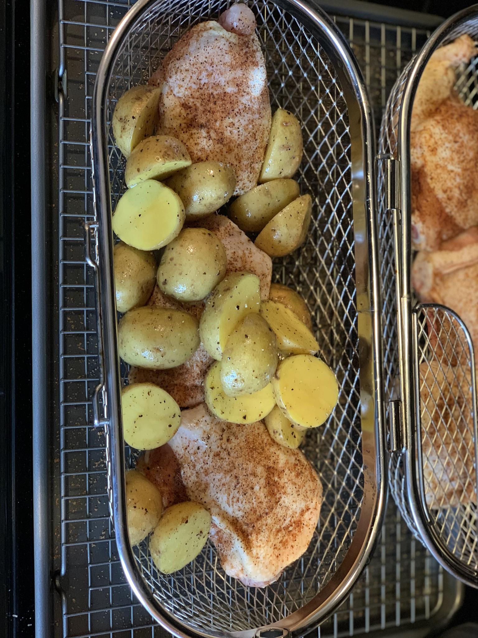 Chicken thighs and potatoes in the rotisserie basket. r/KamadoJoe