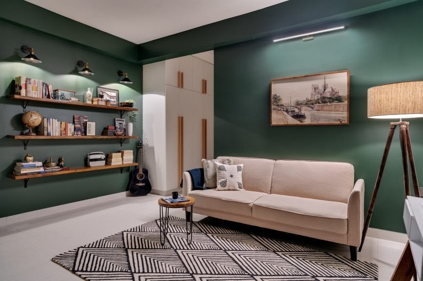 Living room painted with forest green hue and wooden elements add