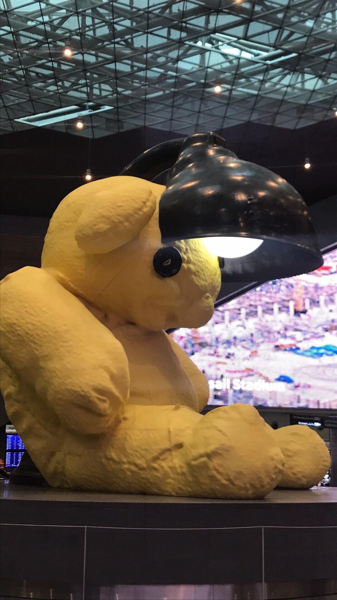 This giant teddy bear has a lamp inside his head, I found him at Doha airport setting alone r