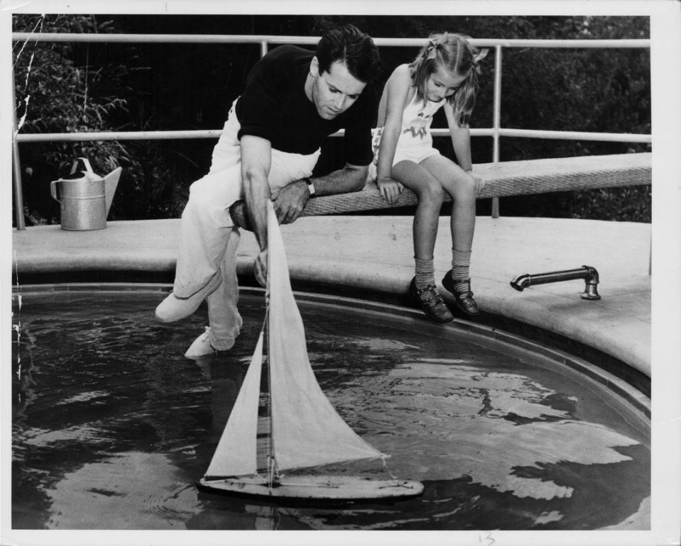 A young Jane Fonda and her father, actor Henry Fonda, play with sailing