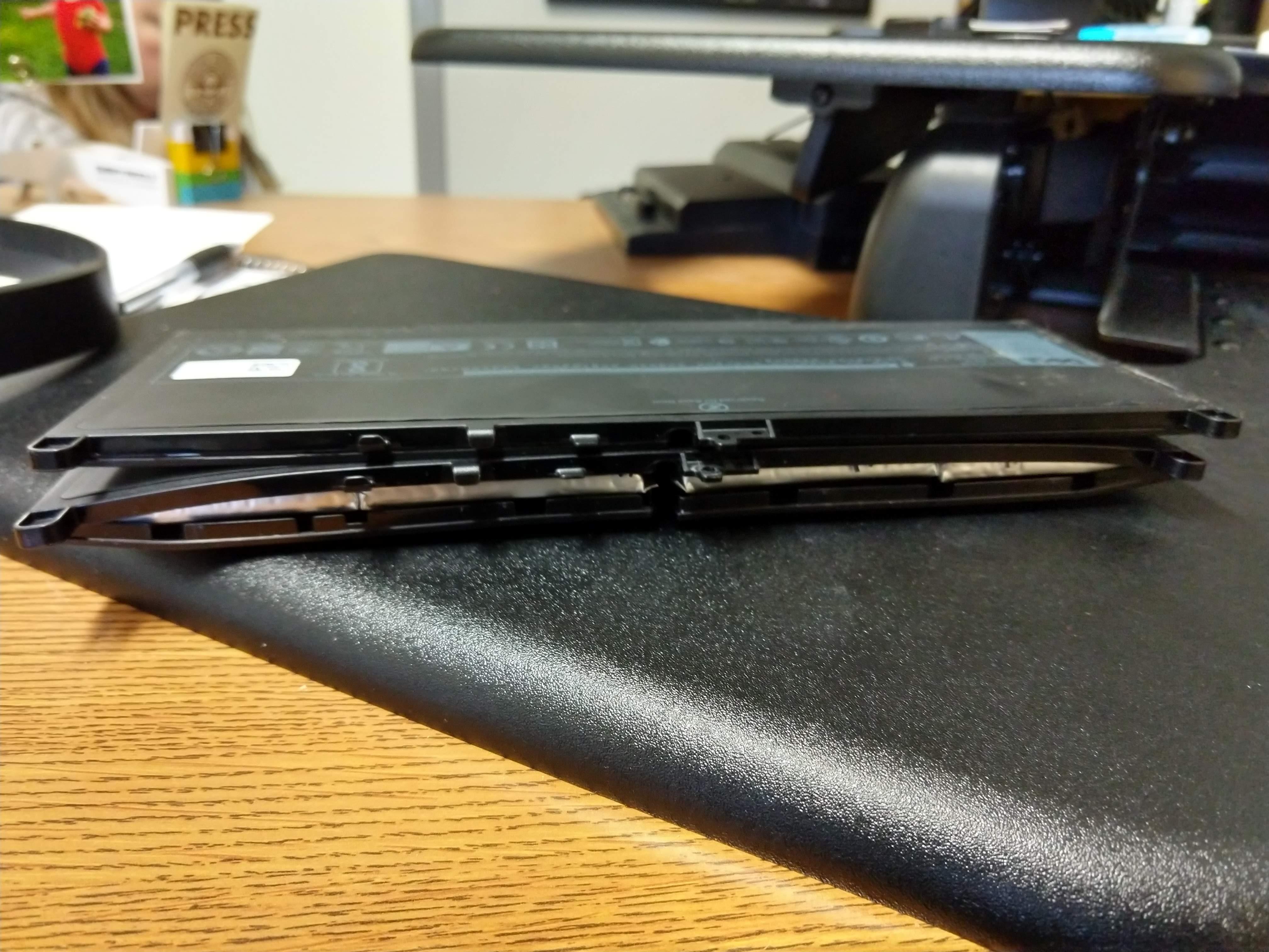 Work laptop battery got a case of the swoles. New battery on top of old