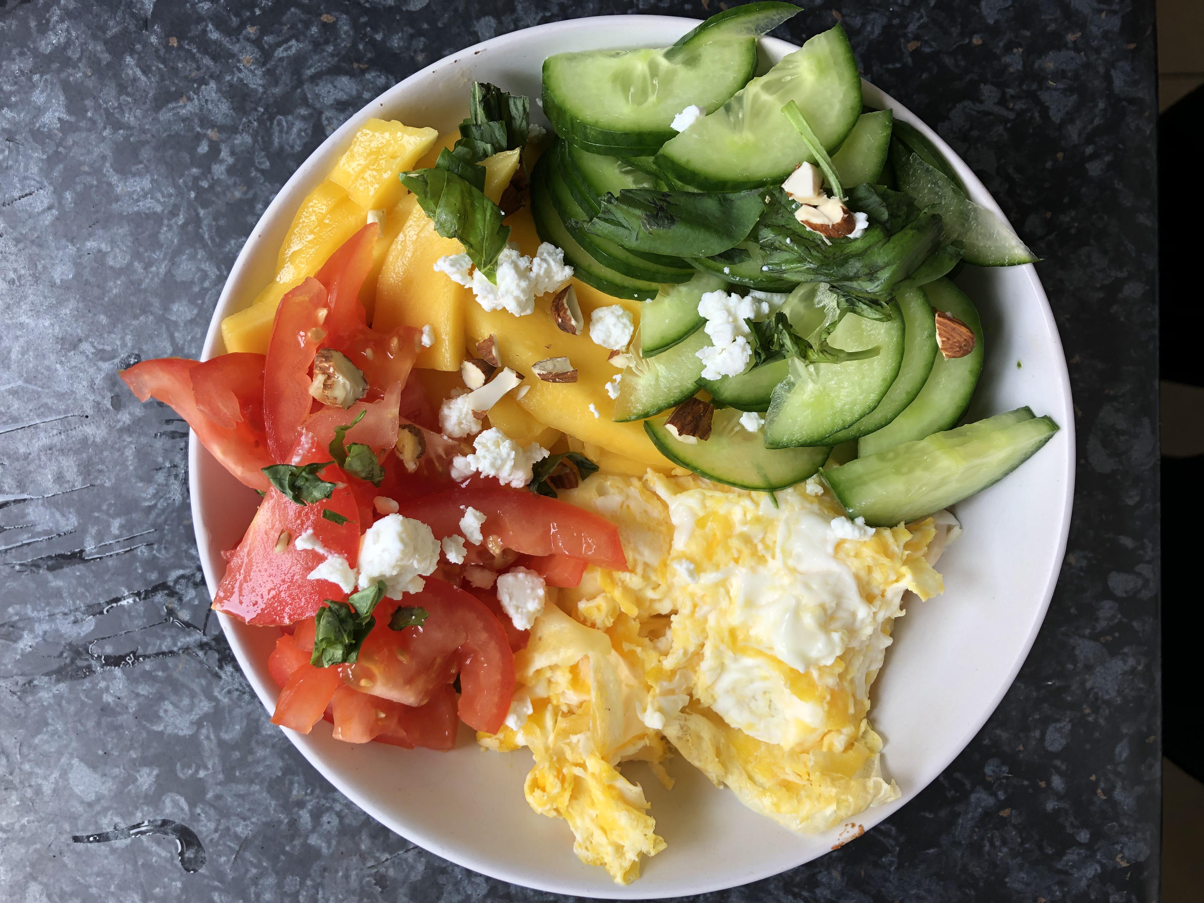Today’s brunch bowl eggs, tomatoes, cucumber, mango, feta, almonds and