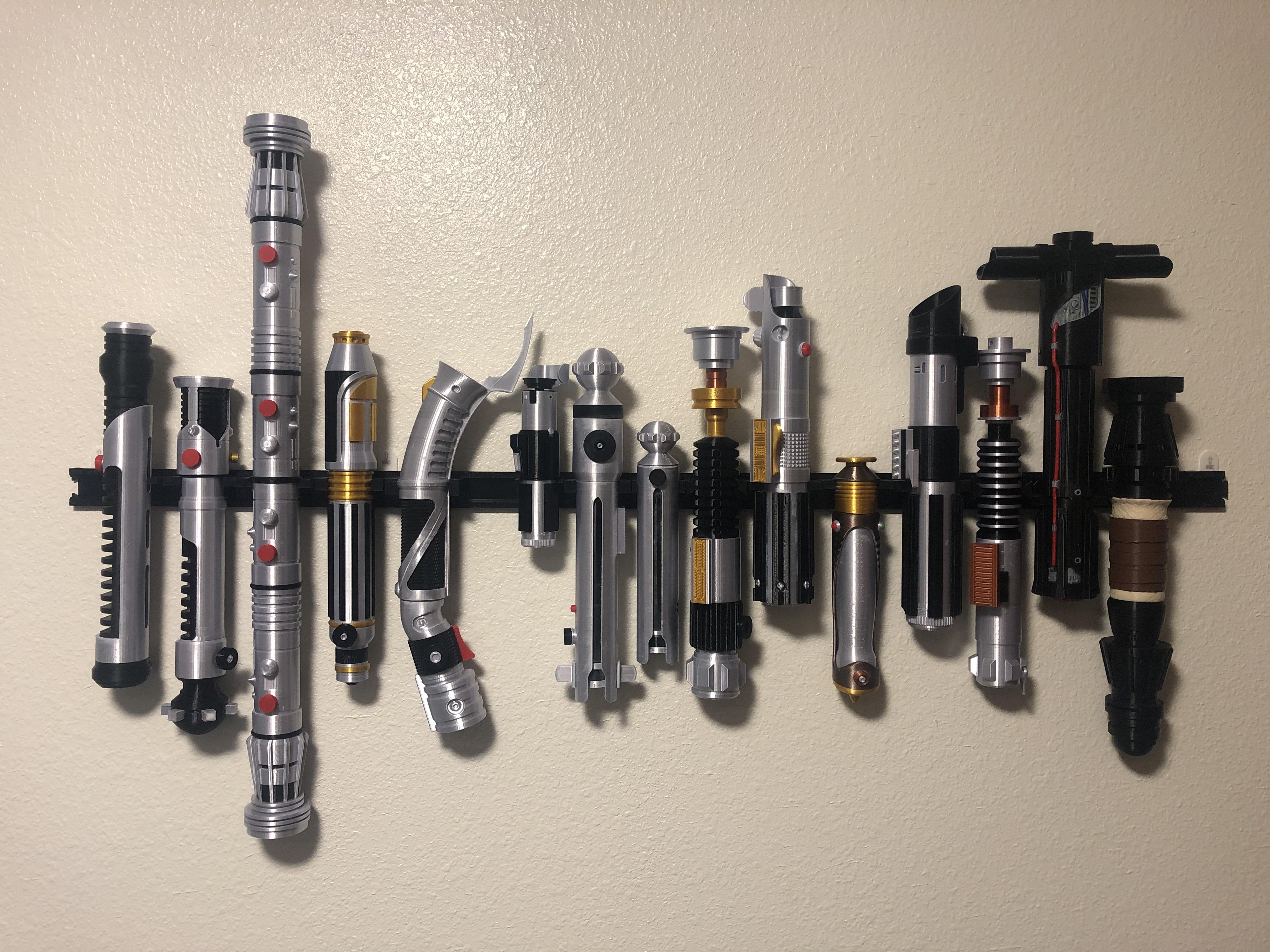 Just finished wall mounting my 3d printed lightsaber set (in canonical order) r/StarWars