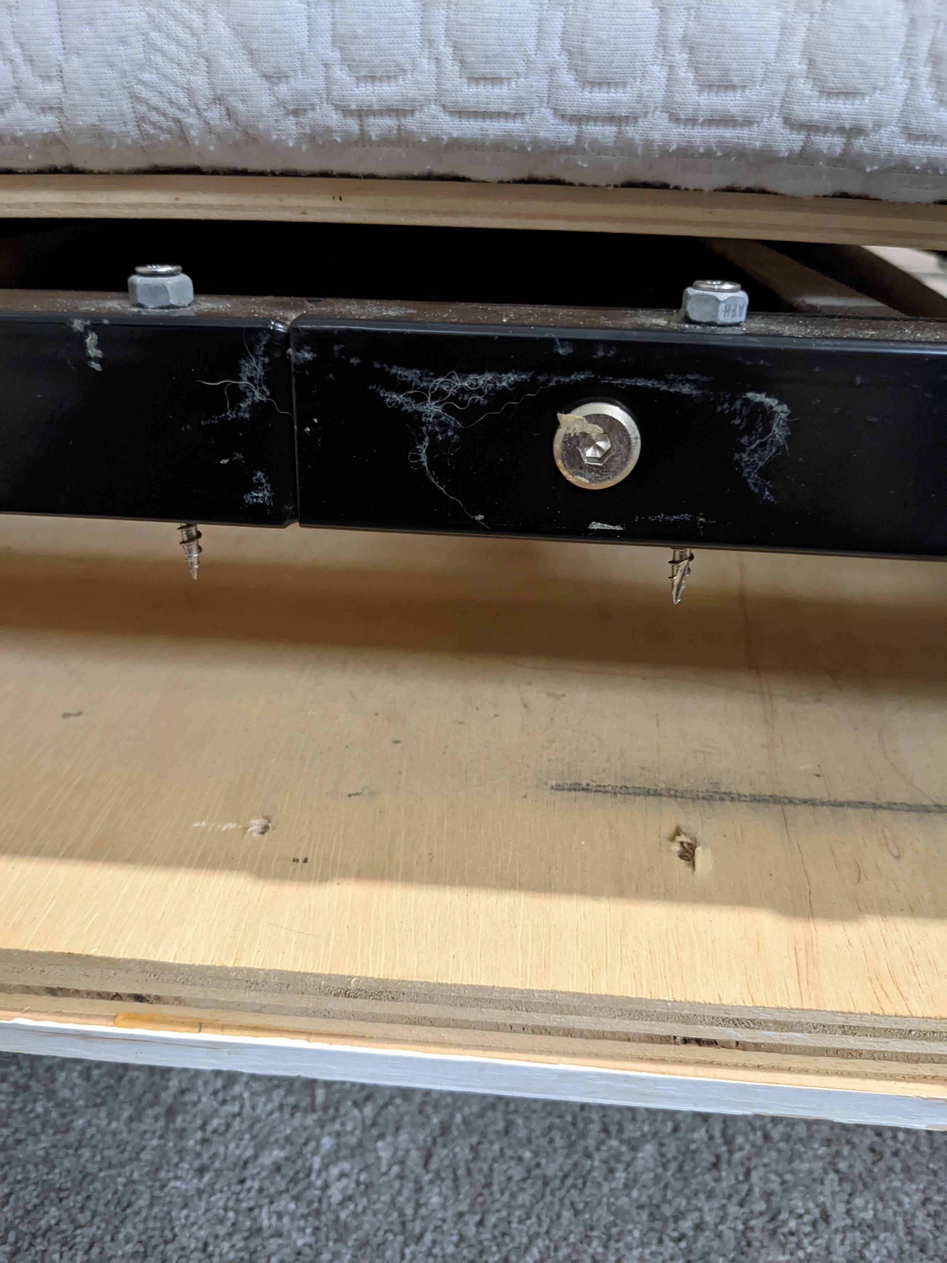 How do I reattach the wooden cover panel to the Murphy bed frame? The original screws I used