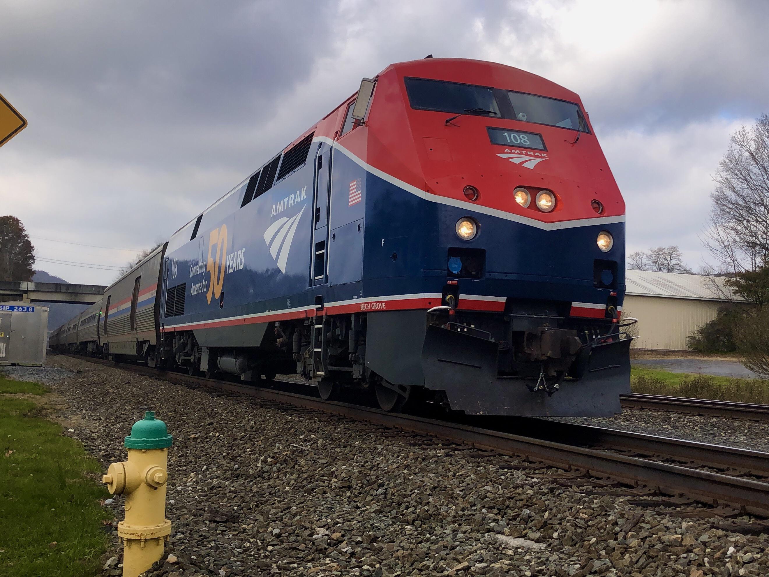 Amtrak locomotive 108 with a 50th Anniversary paint job leads the