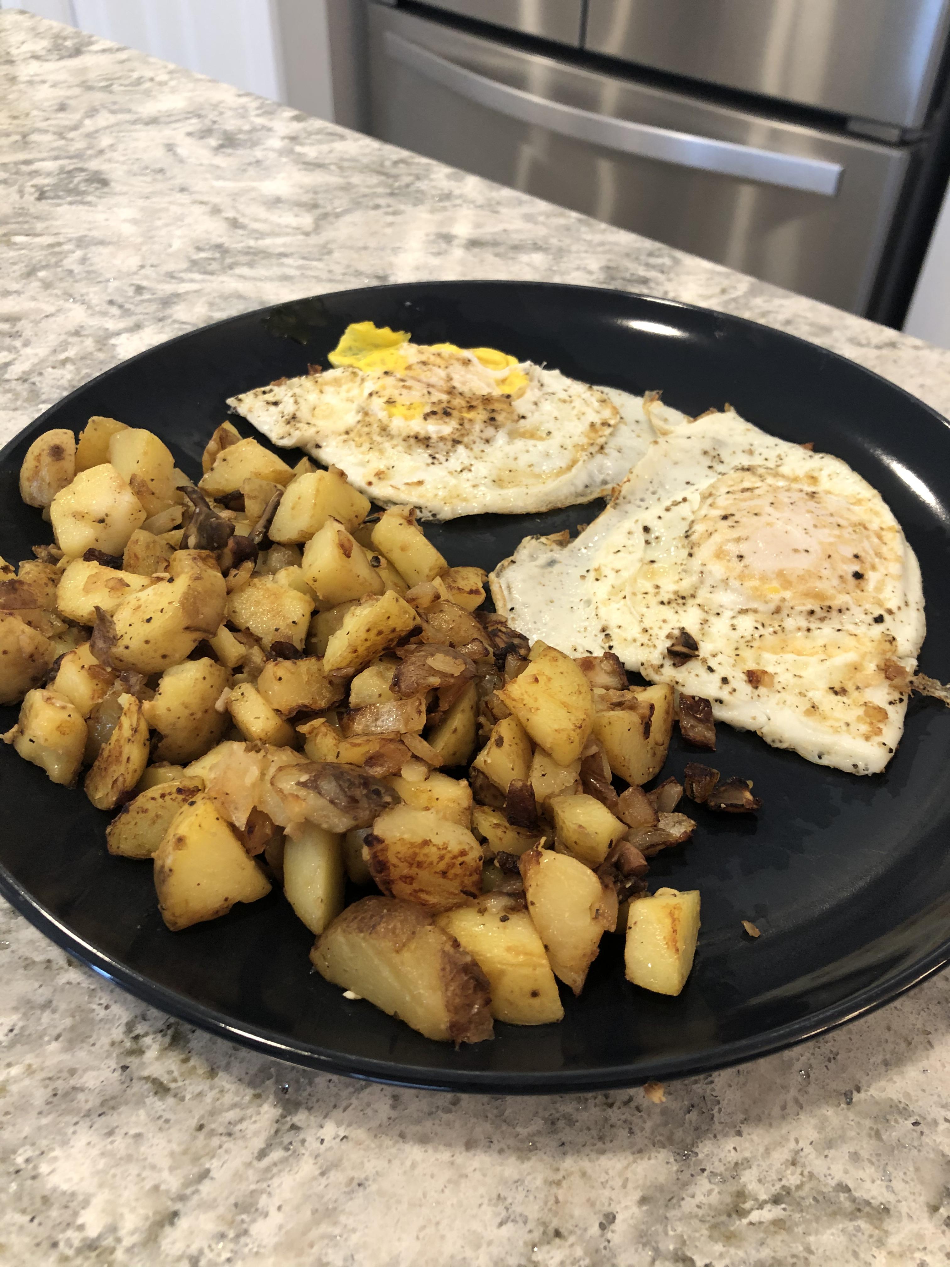 Breakfast today two eggs with potatoes, onions and mushrooms sautéed