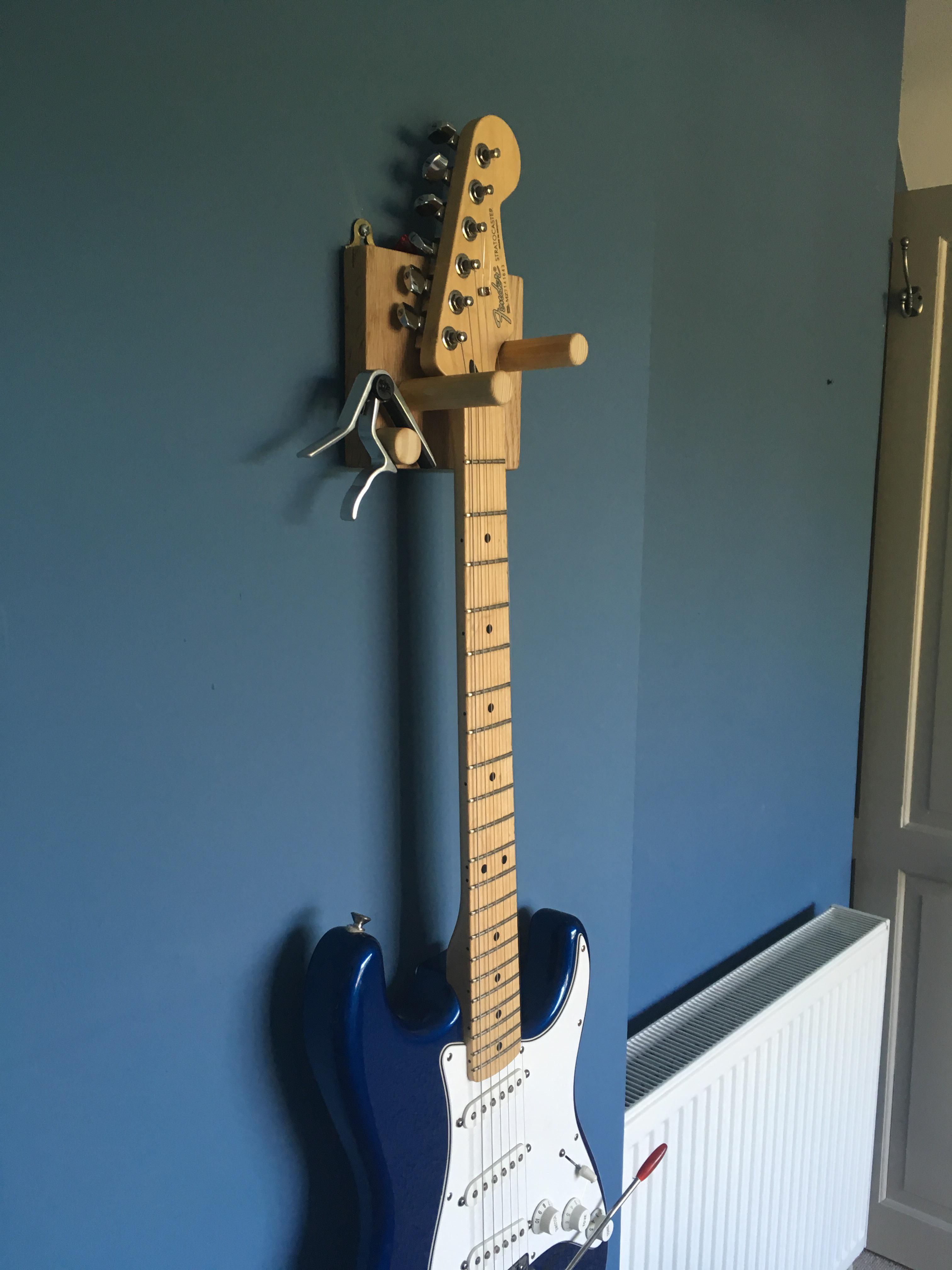 Made this wall mount holder for my fender strat, pretty happy with it