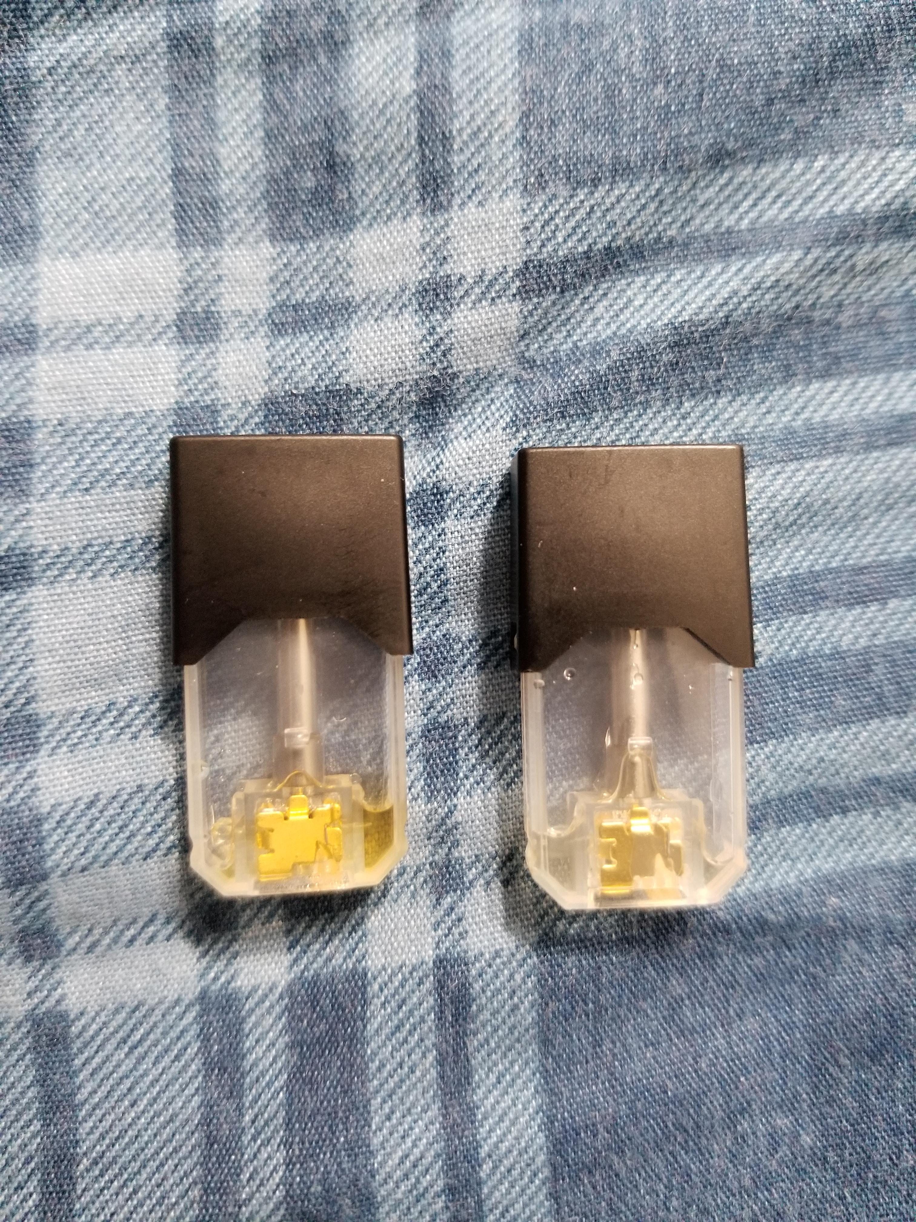 Used Cool Mint pod from the old packaging and a used Cool Mint pod from