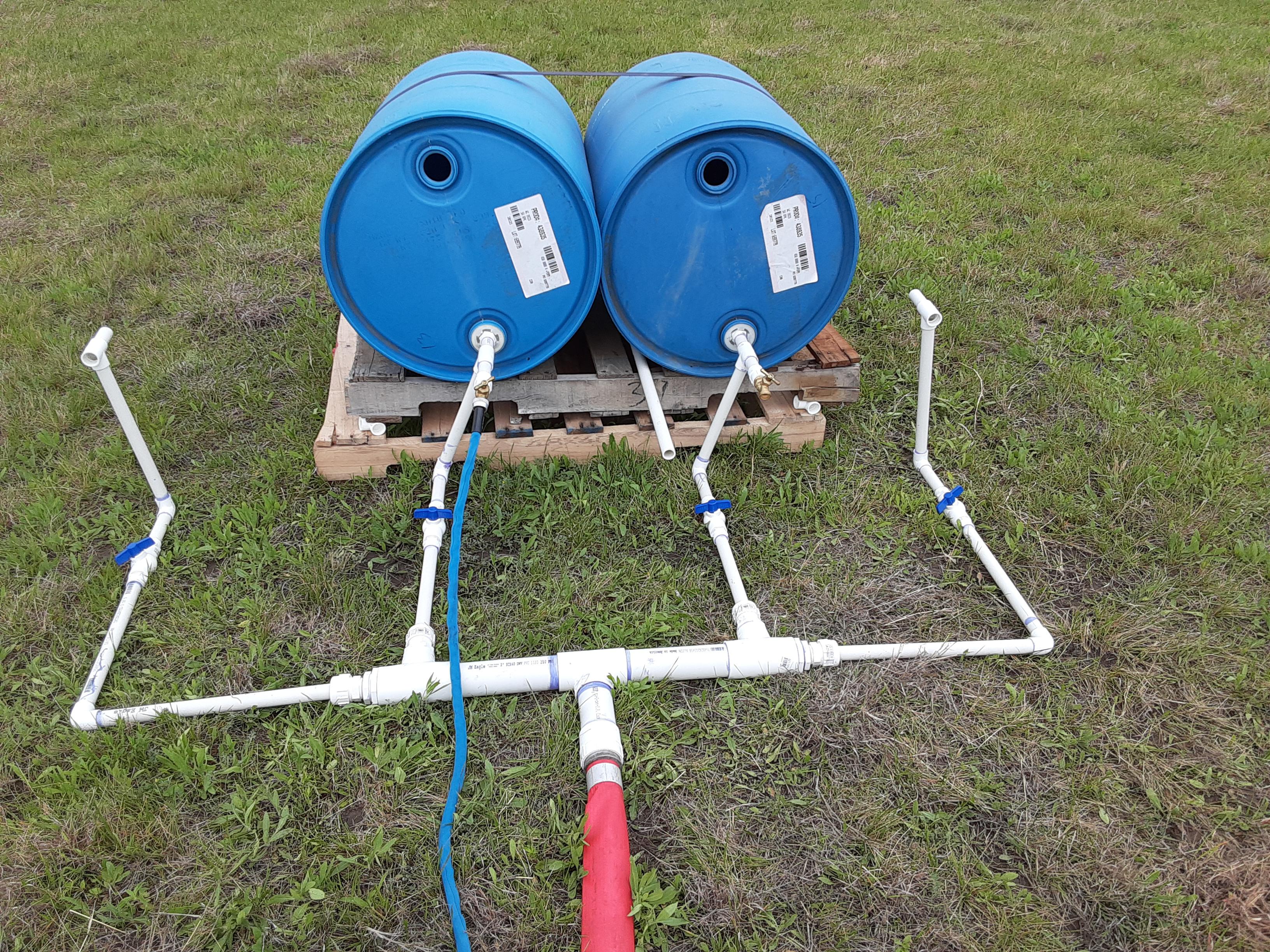 Creating a drip irrigation system. More barrels are on the way. Filling