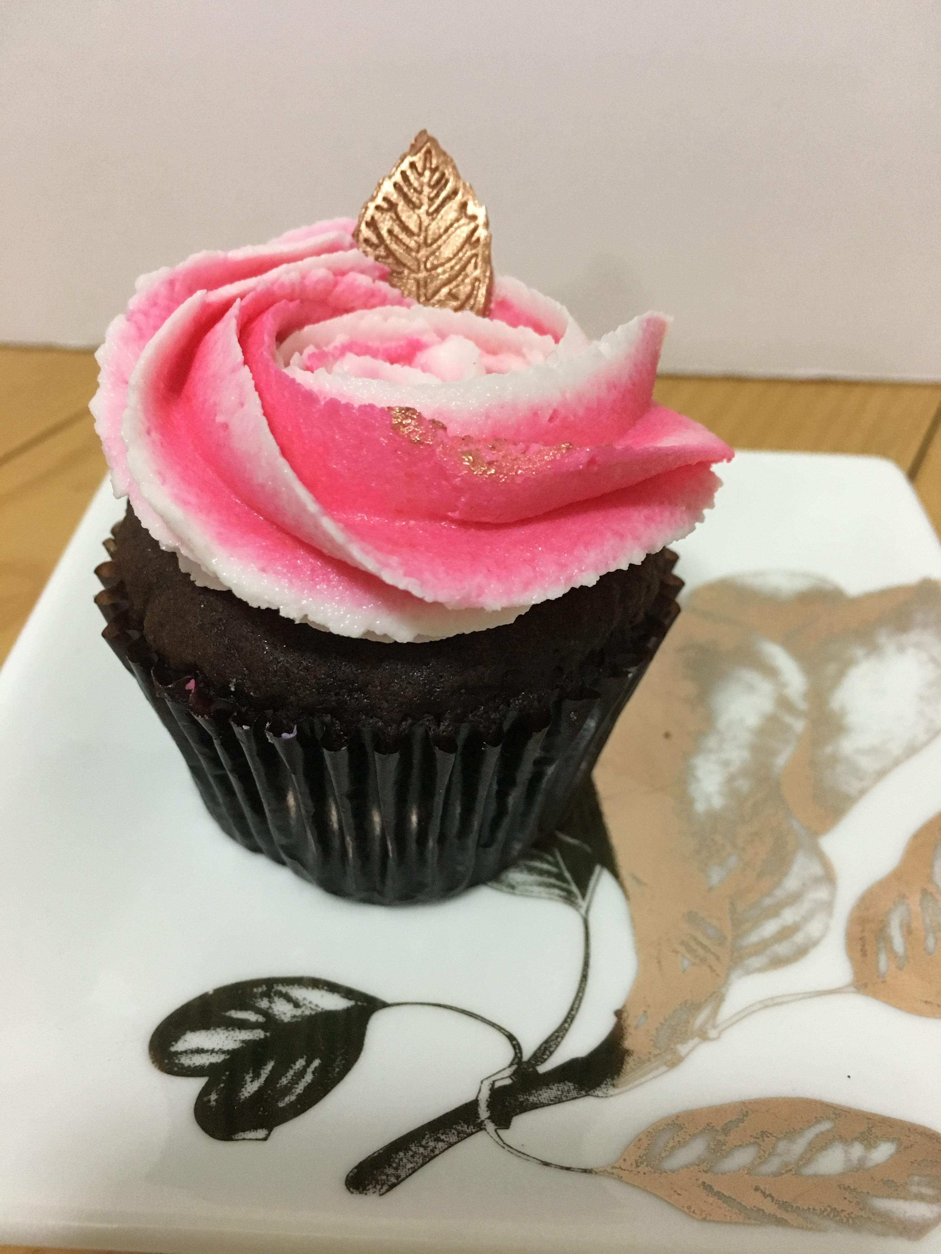 Chocolate cupcake with almond butter cream. I used fondant for the leaf