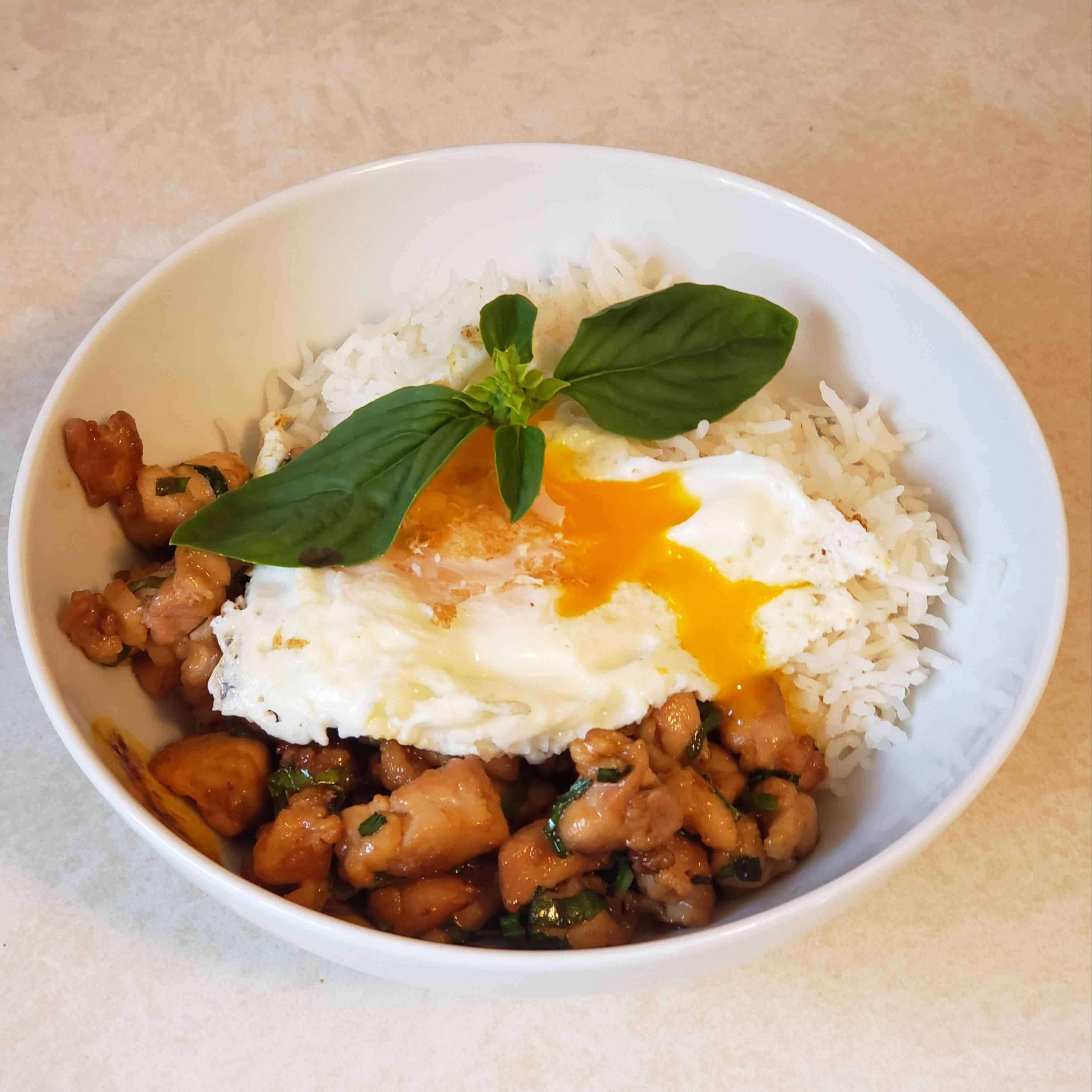 Spicy Thai basil chicken with basmatti rice and a fried egg. Highly