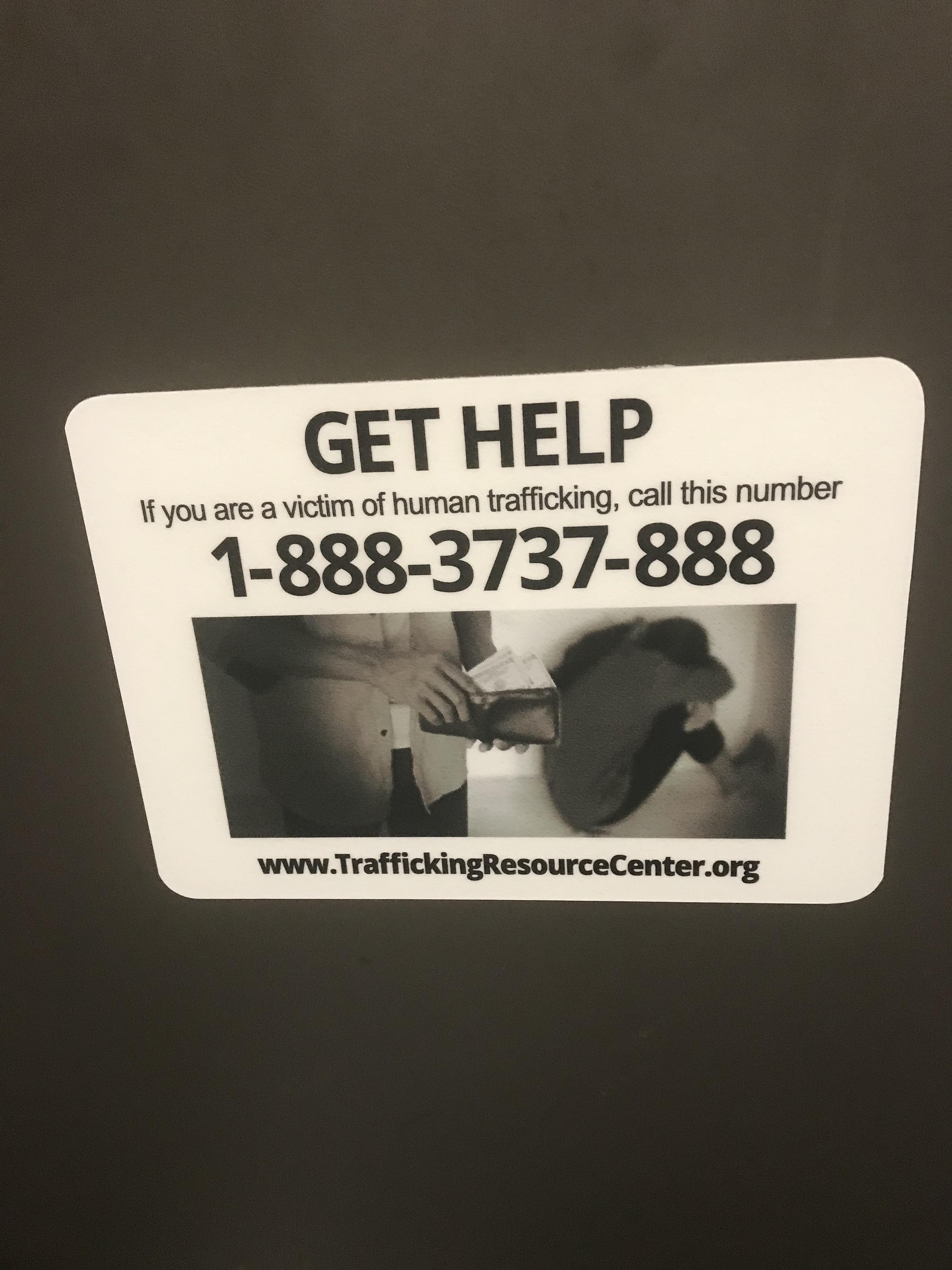 Human Trafficking sign in bathroom stall of McCarran