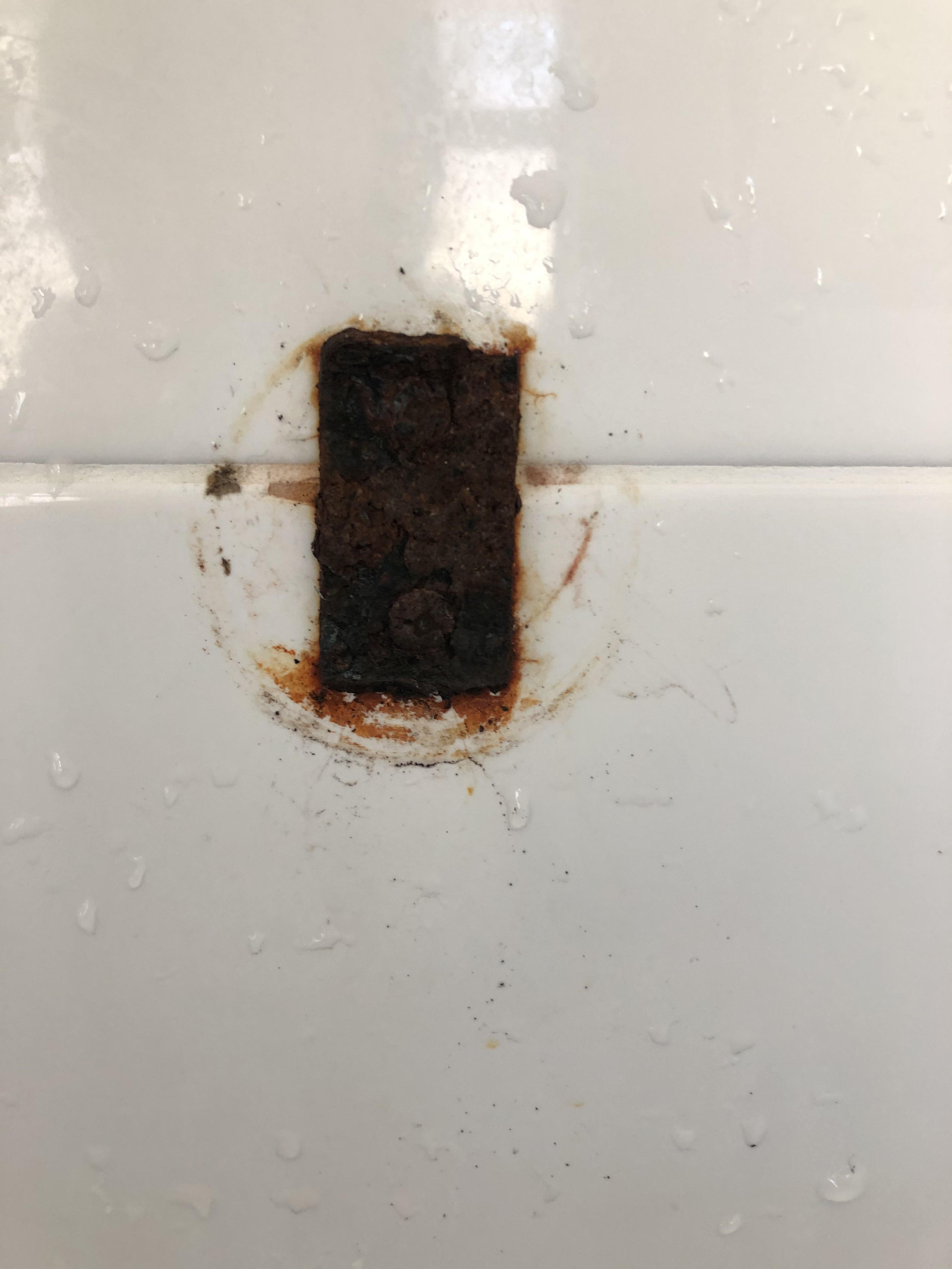 How to remove this rusted soap dish mount from my shower tiles? The