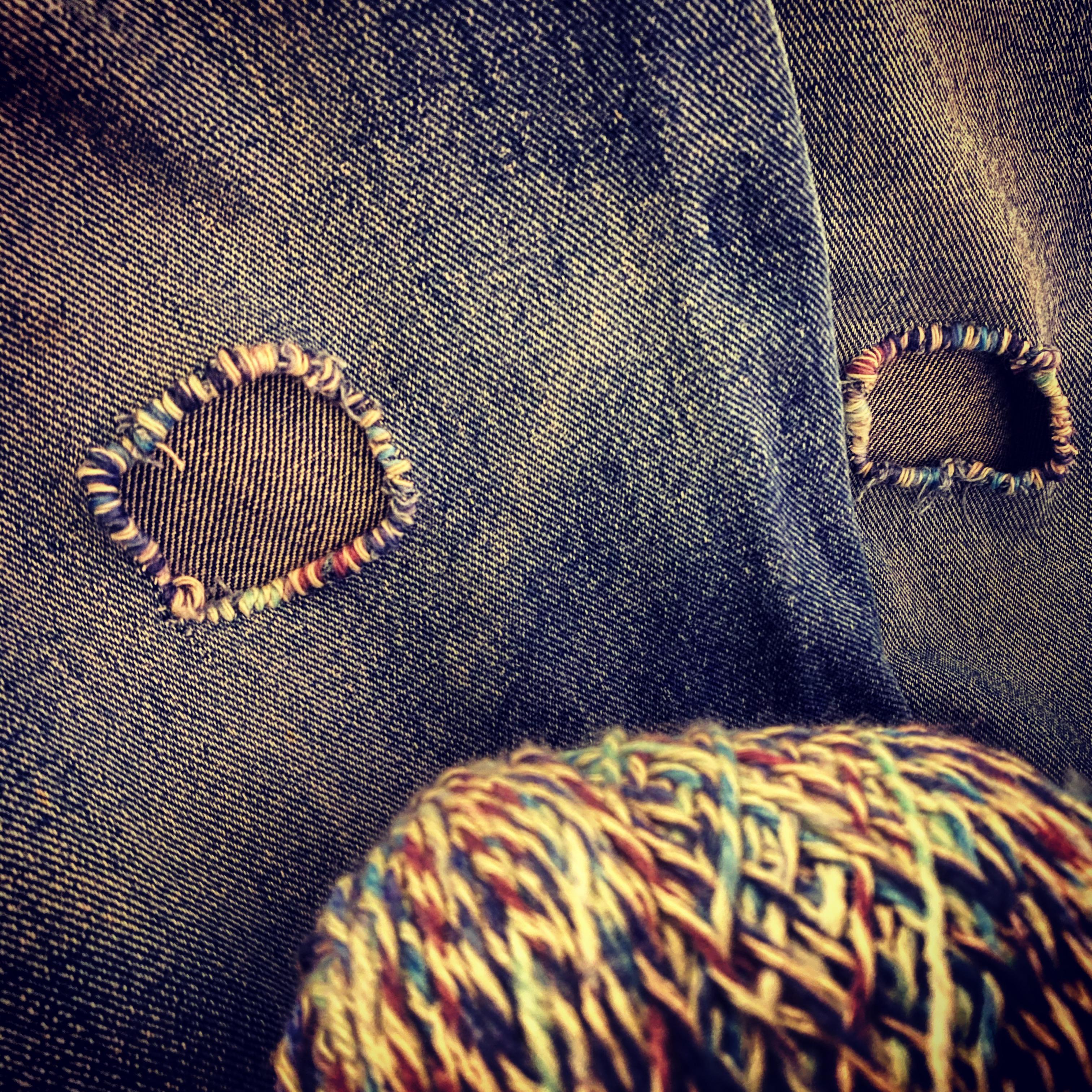 Knee holes reinforced with rainbow yarn. r/Visiblemending