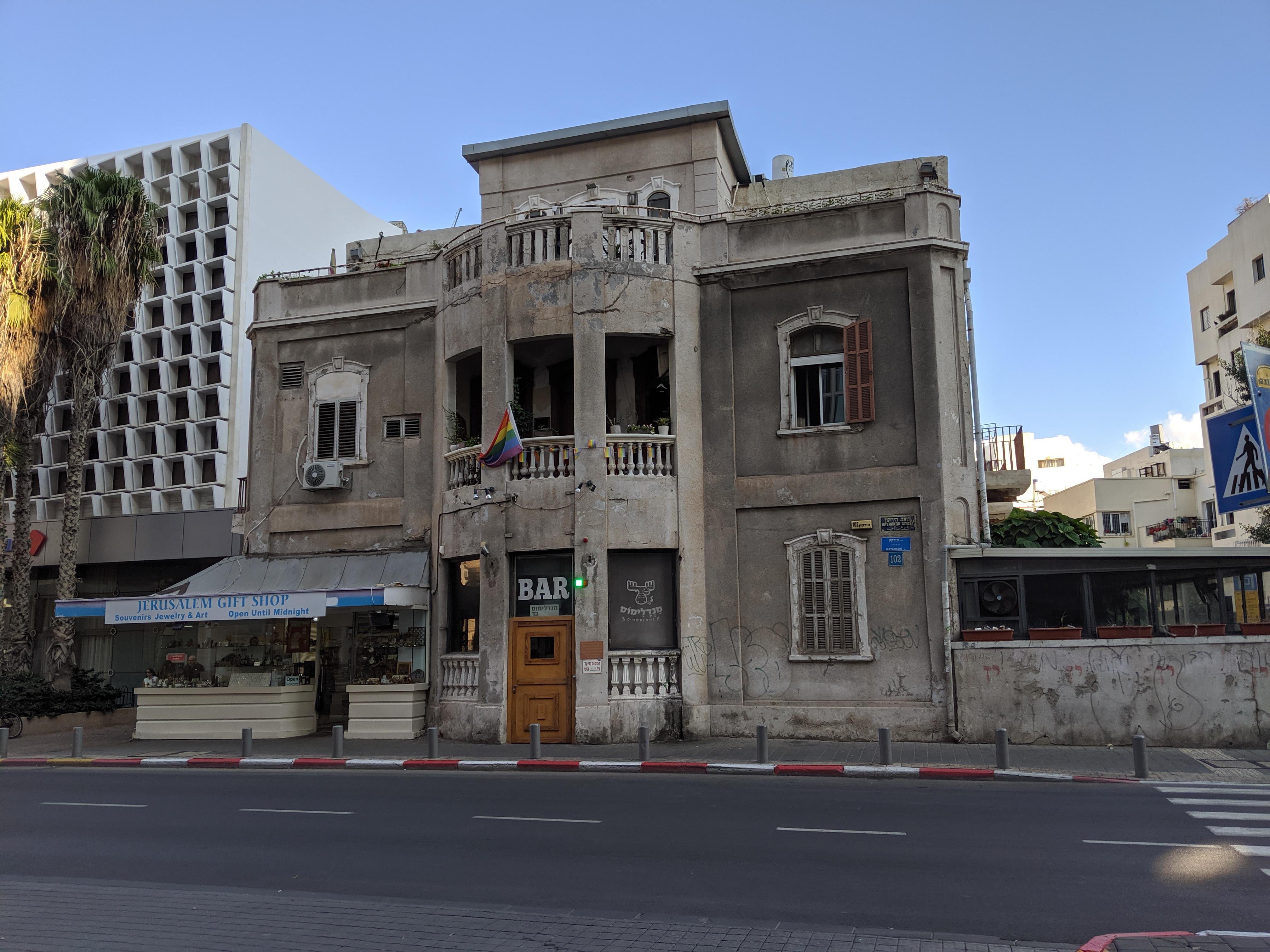 A bar, a gift shop and an LGBT flag meet in a rundown architectural gem (Tel Aviv, Israel) r