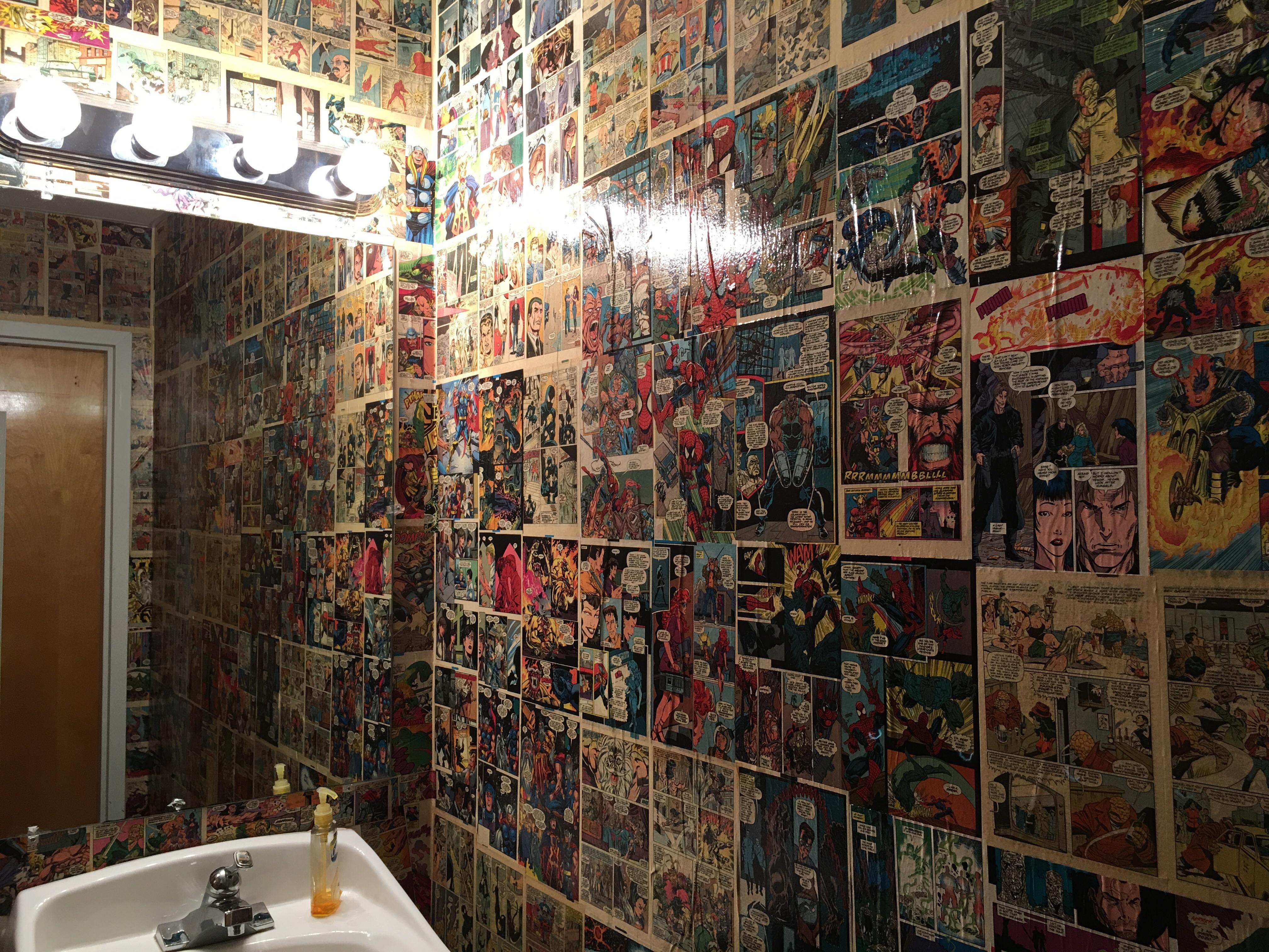 Walls (and floors) of a local tattoo shop covered in comic pages