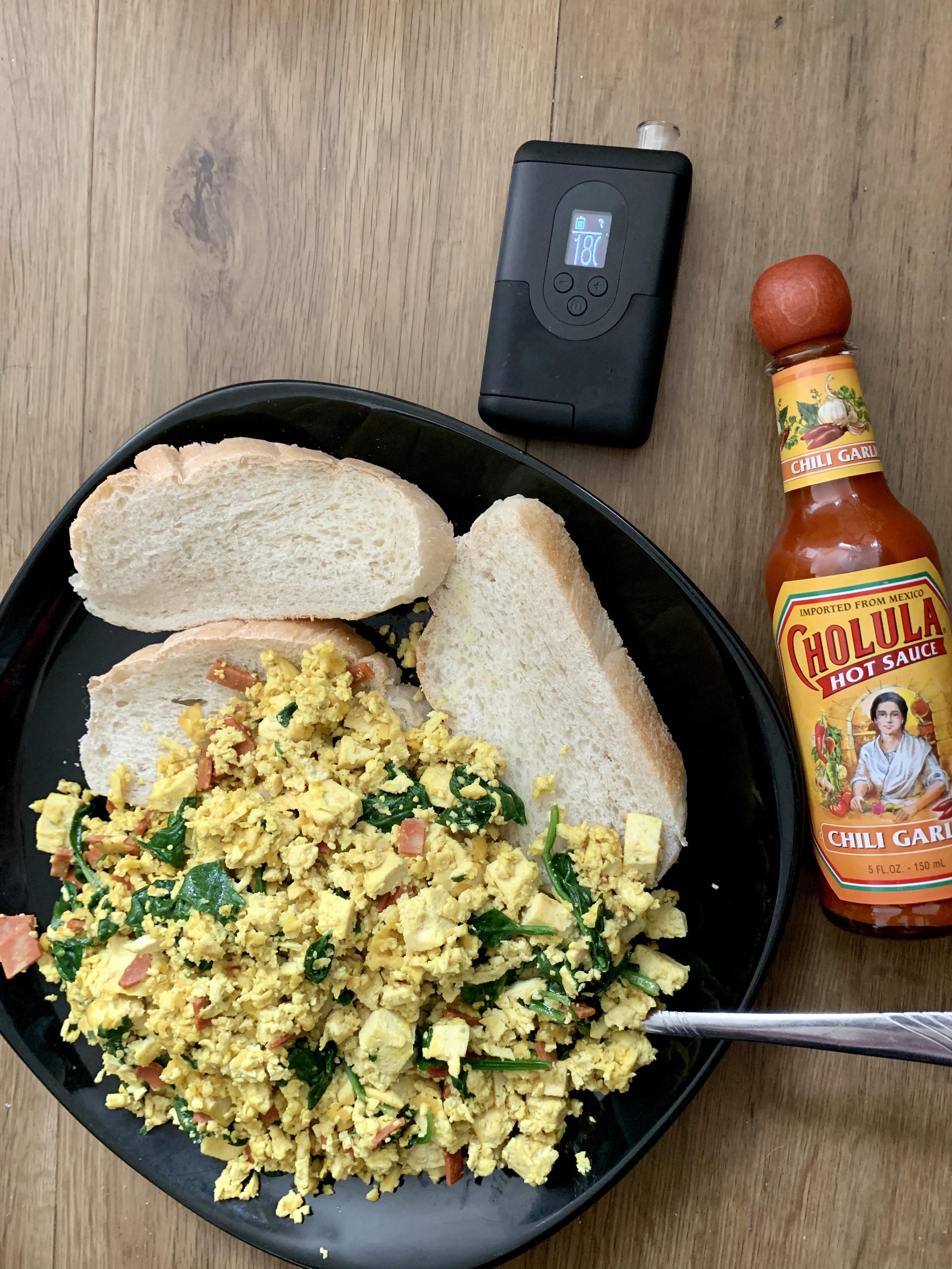 Tofu scramble with spinach and “bacon”, homemade bread, hot sauce and