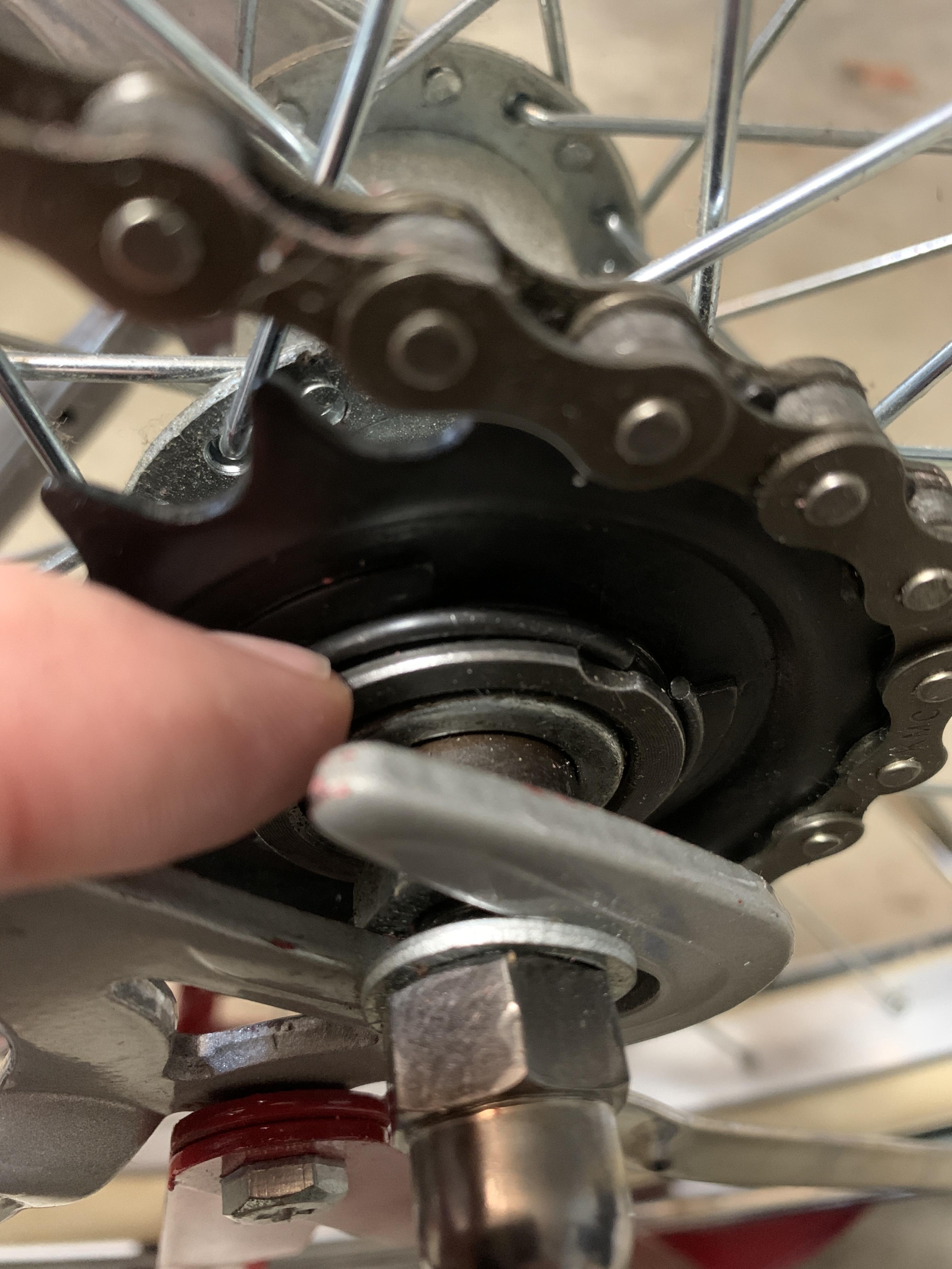 Rear gear on onespeed bike keeps falling off. This small band I am pointing at in the picture