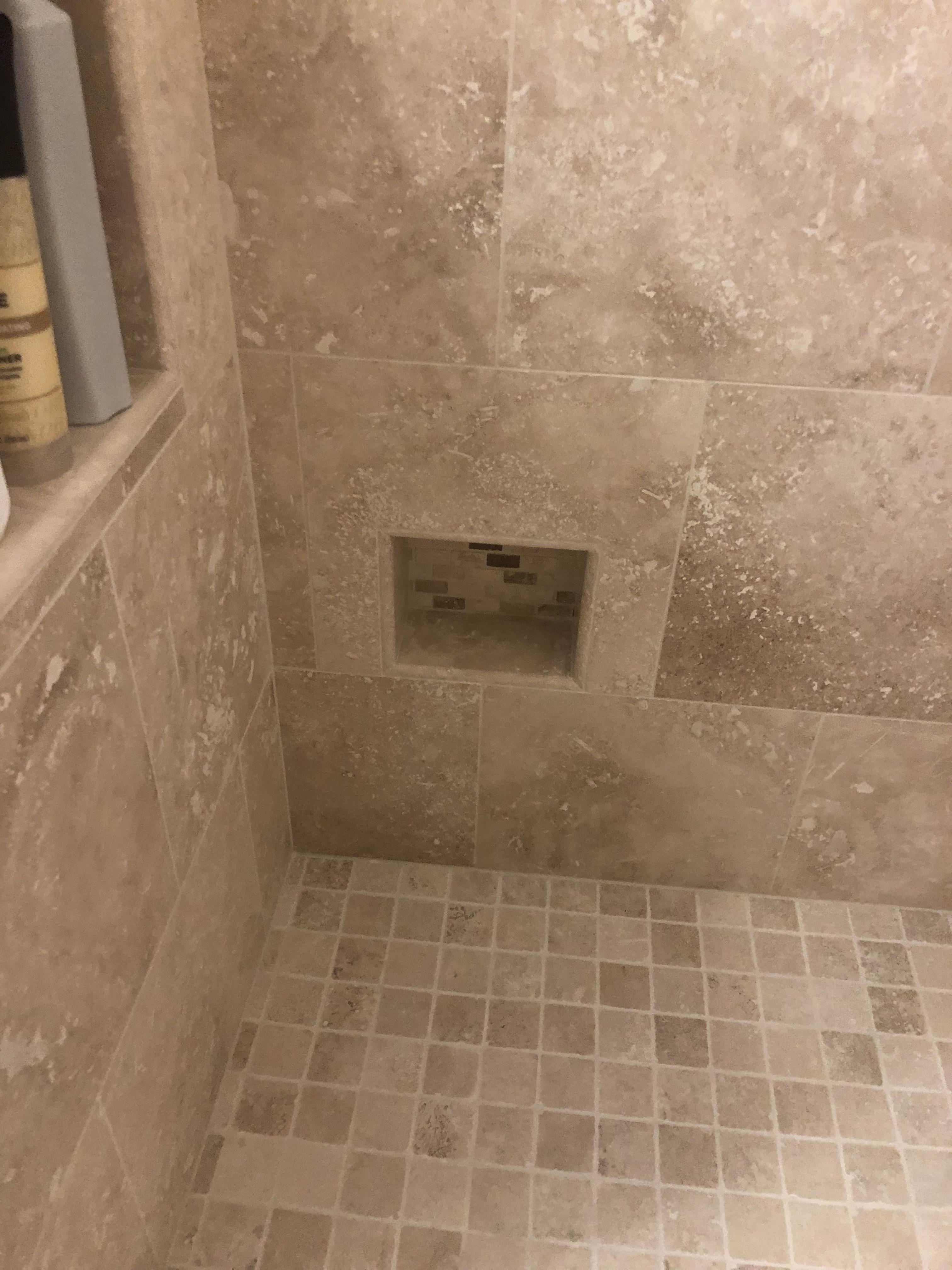 This shower has a nook where you can rest your foot to shave your legs