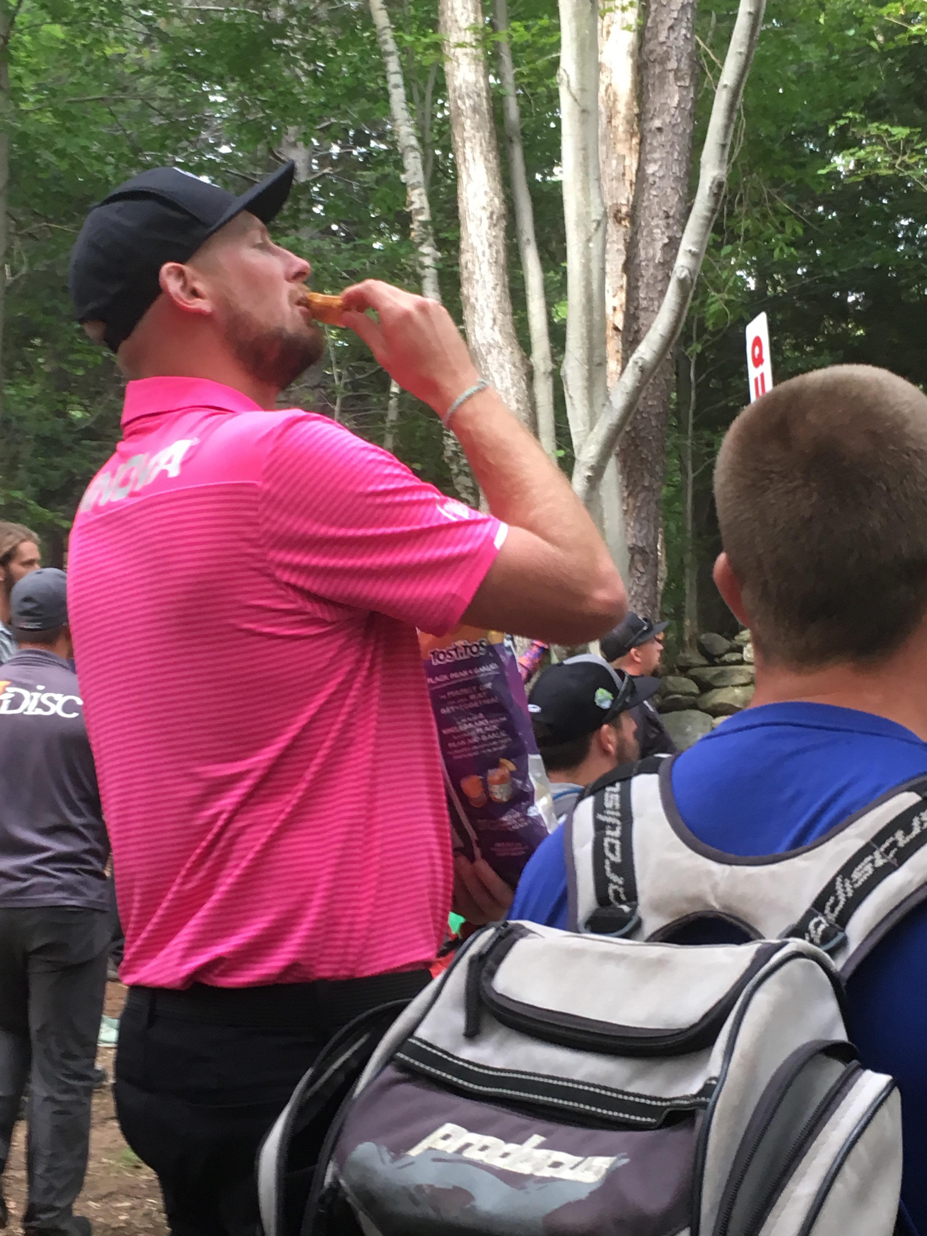 Big Jerm with a big bag of Tostitos watching final round lead card r