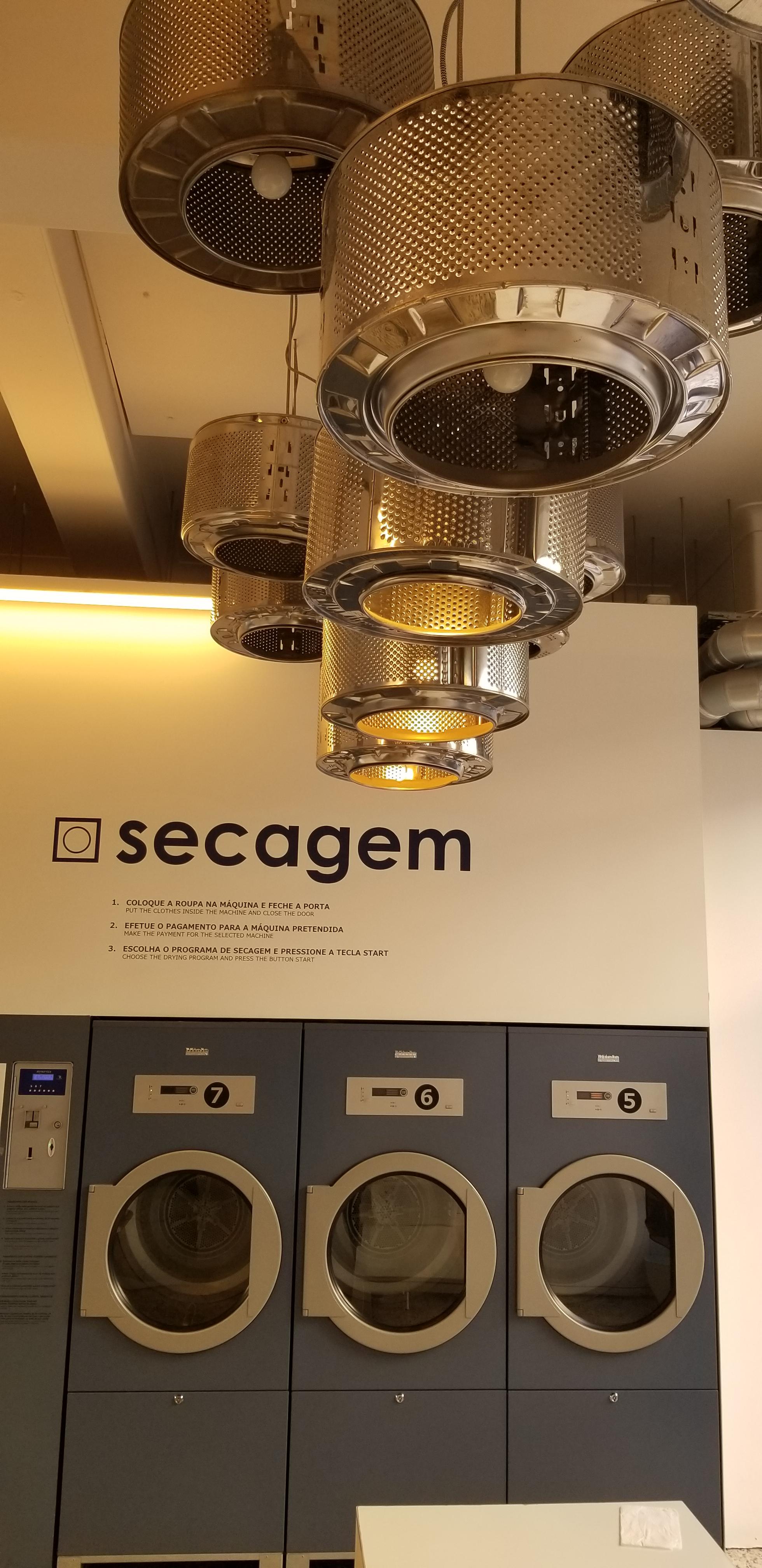 This laundromat has old washing machine drums as chandeliers. r