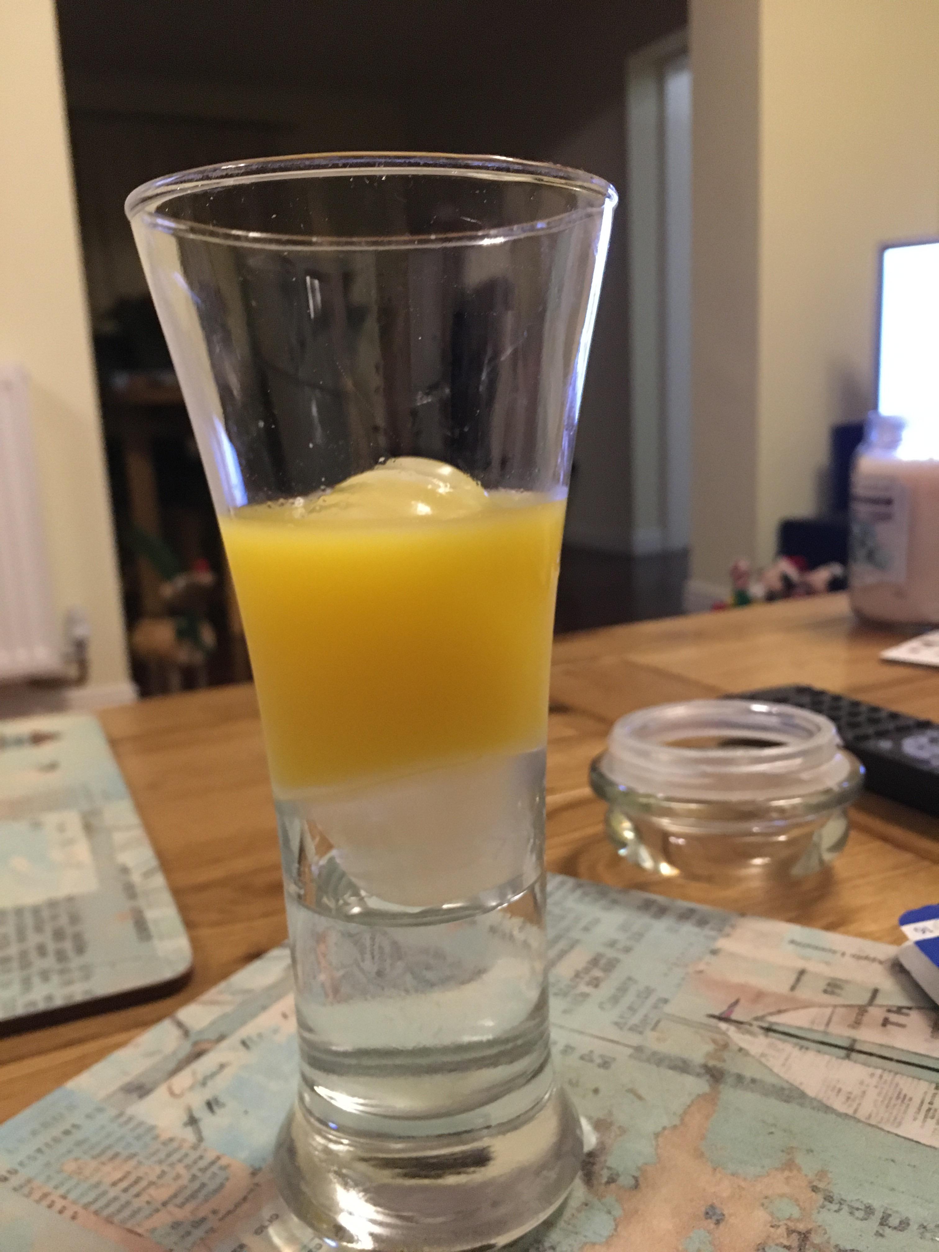 Ice cube acting as a bung between vodka and orange juice r