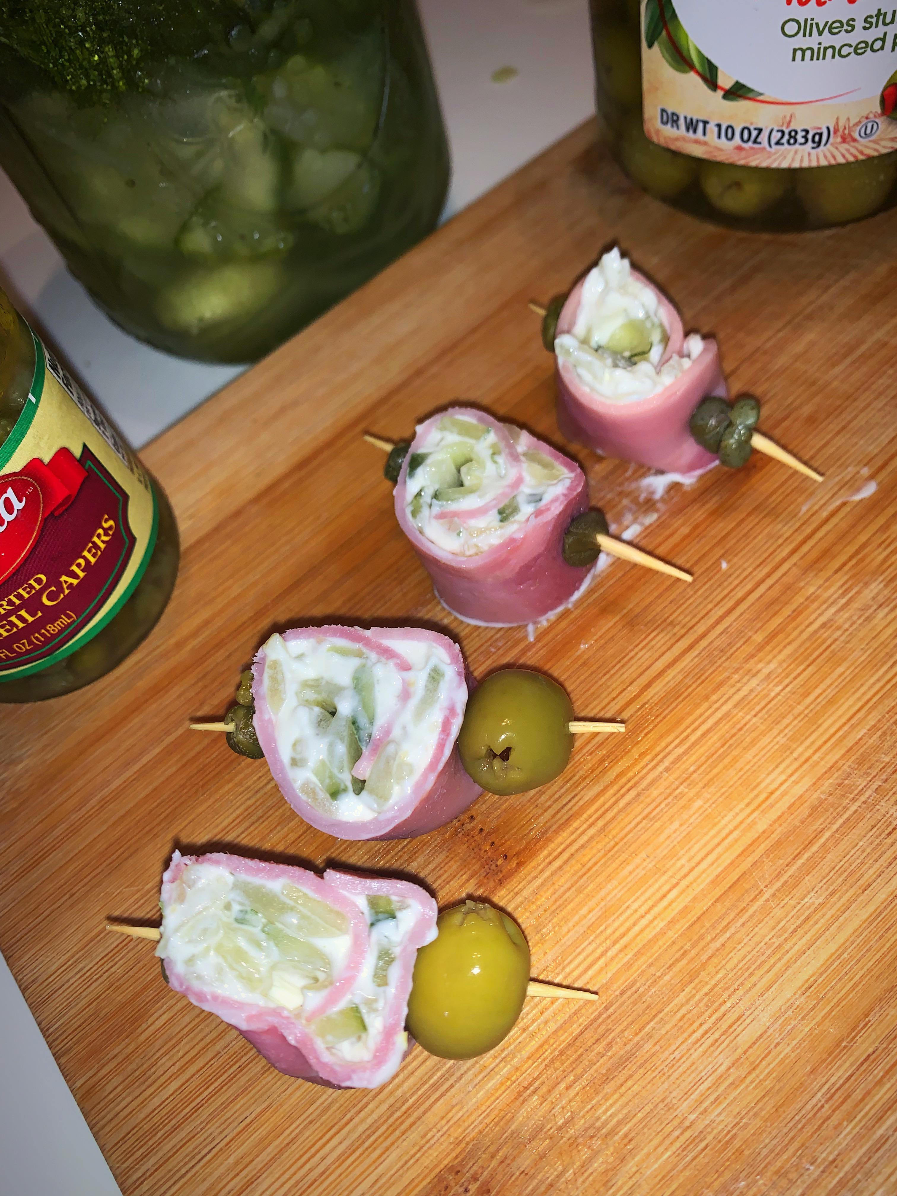 Homemade dill pickles chopped in cream cheese, rolled up in smoked ham
