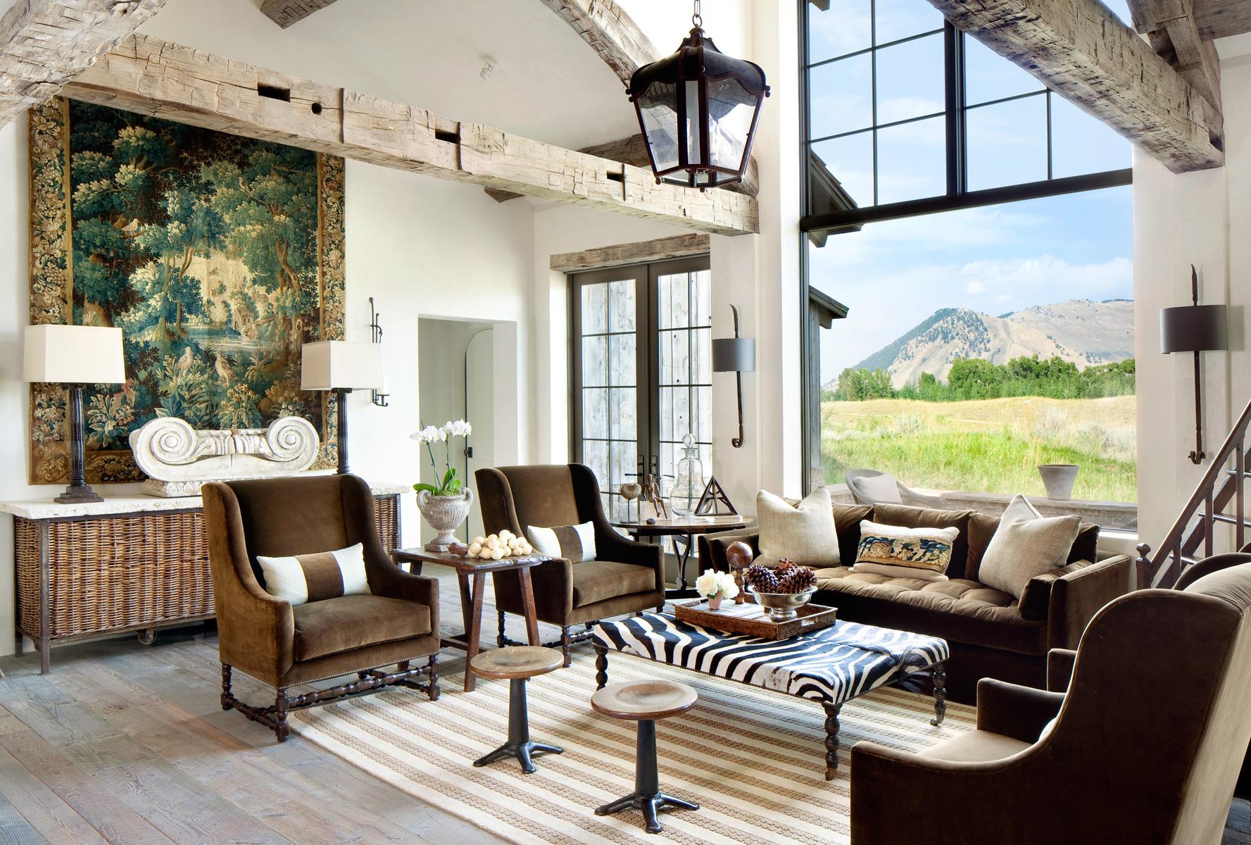Living room decorated with reclaimed wood and antiques looks out at