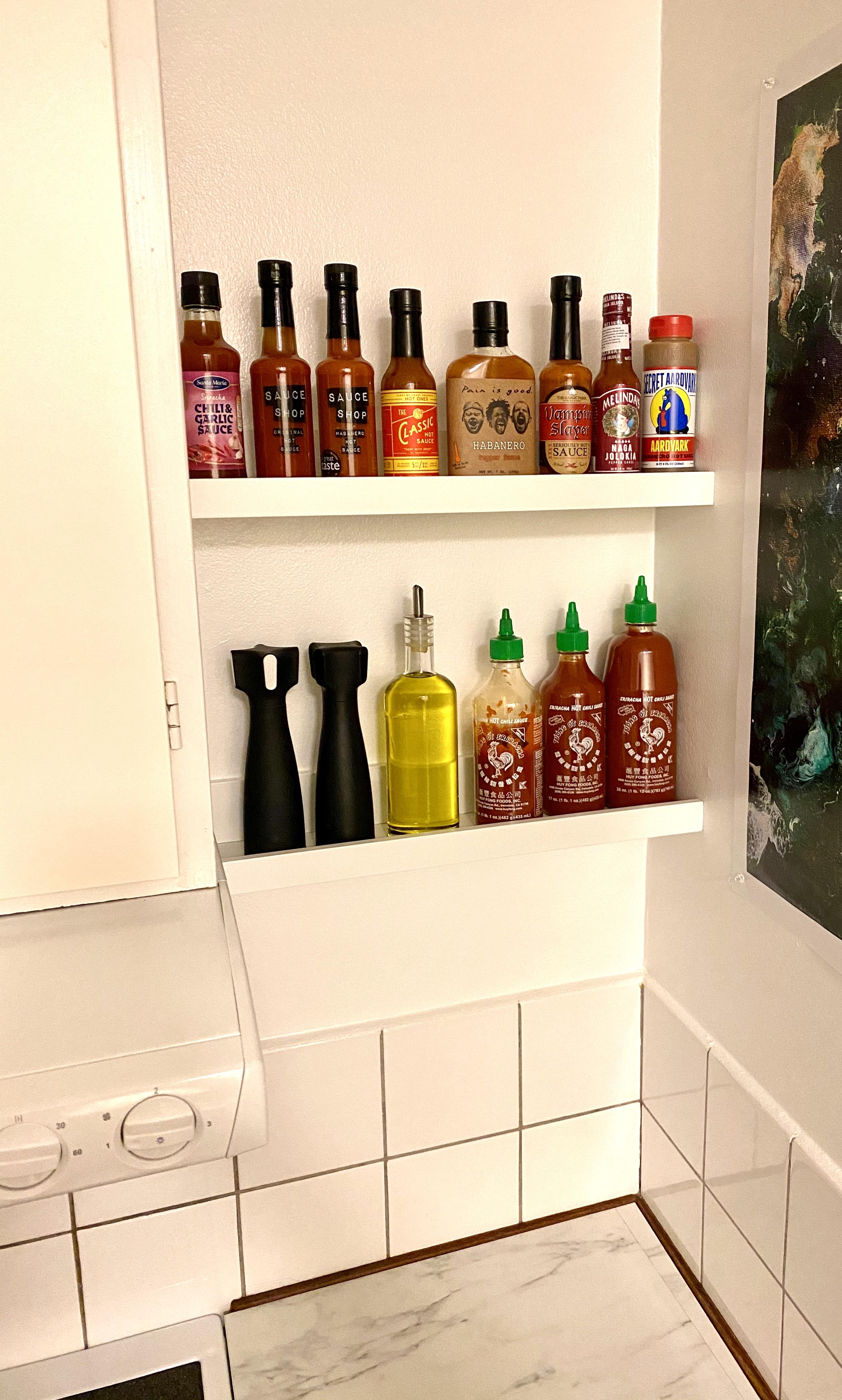Made a hot sauce shelf out of an IKEA picture ledge. No more keeping