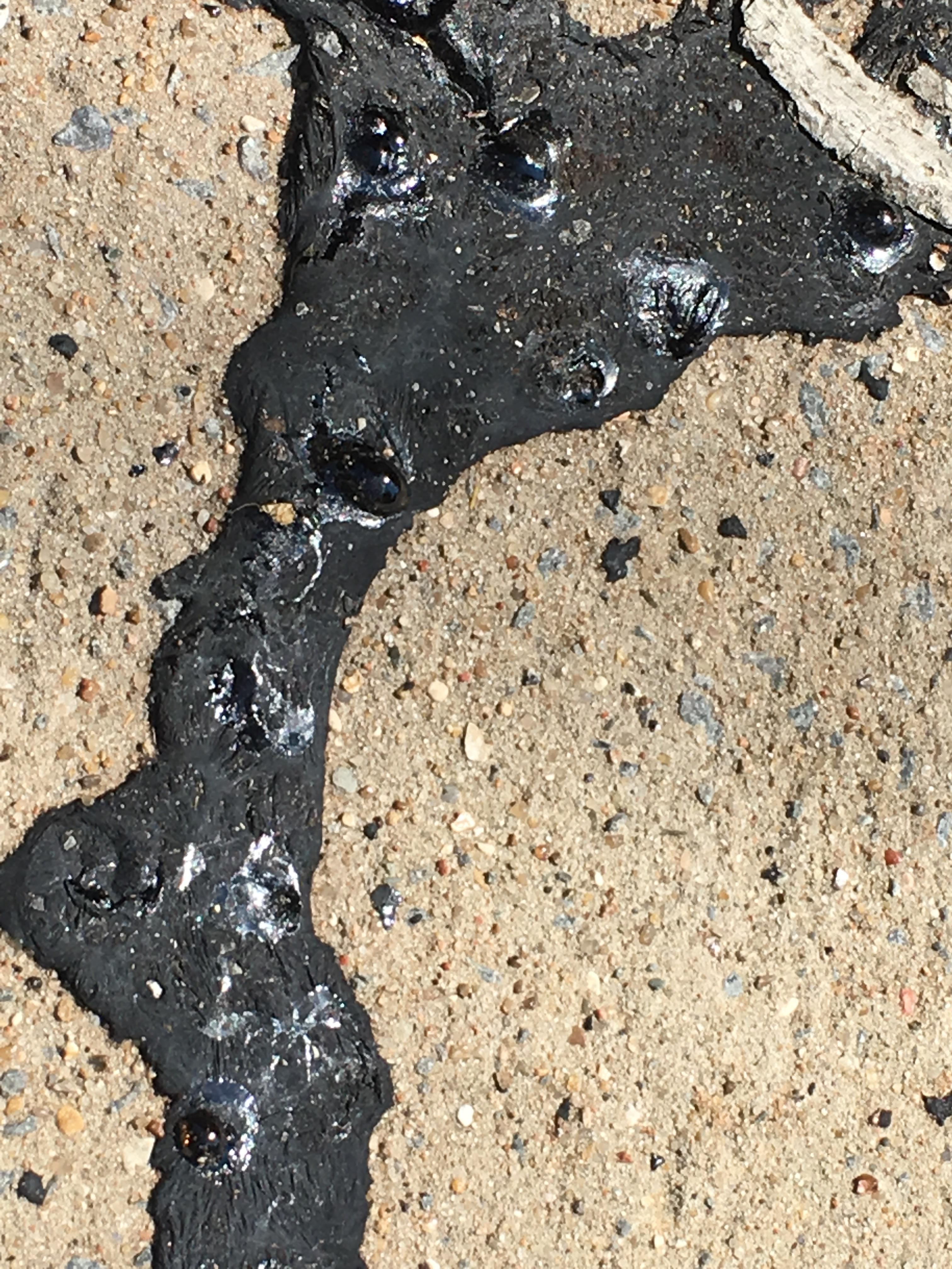 It's so hot outside that the sidewalk tar is melting. r/mildlyinteresting
