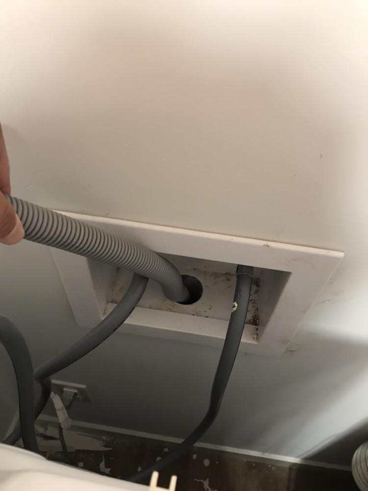Washing machine drain line goes into hole in the wall but isn’t