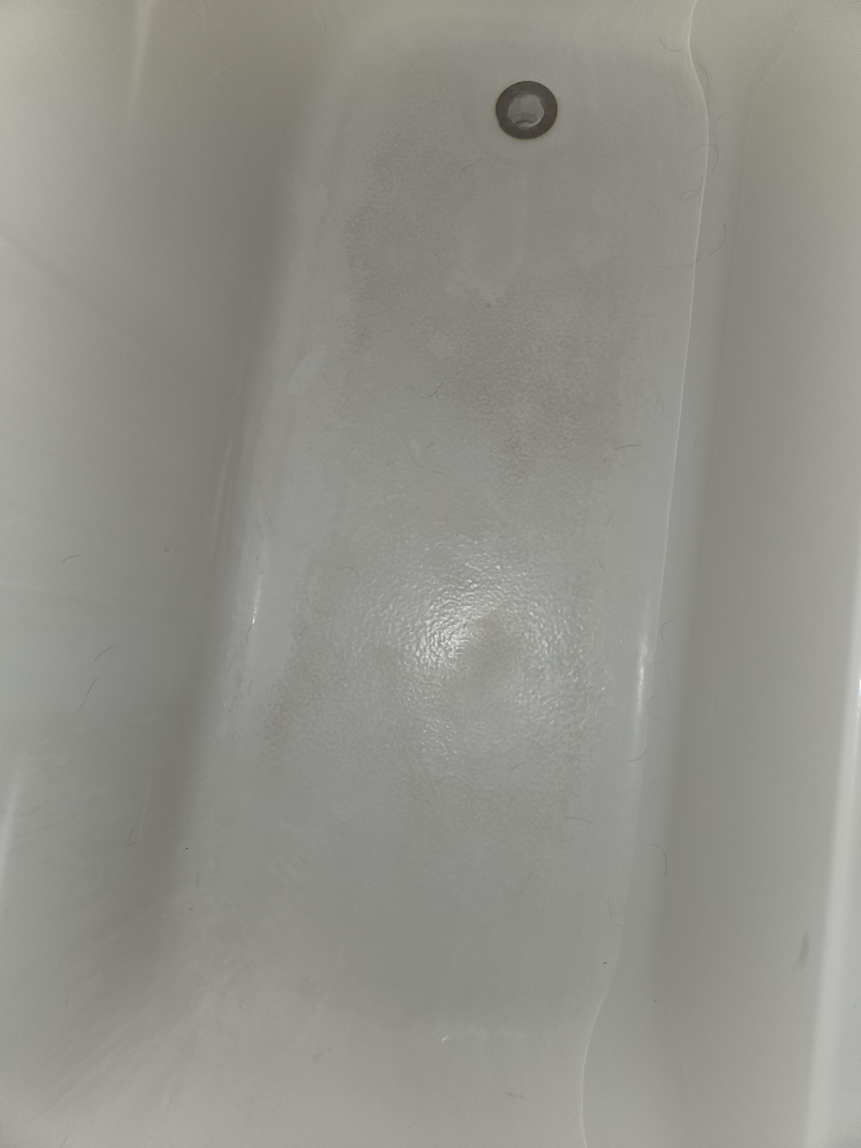 The bathtub floor is filled with this weird...black stain of some kind