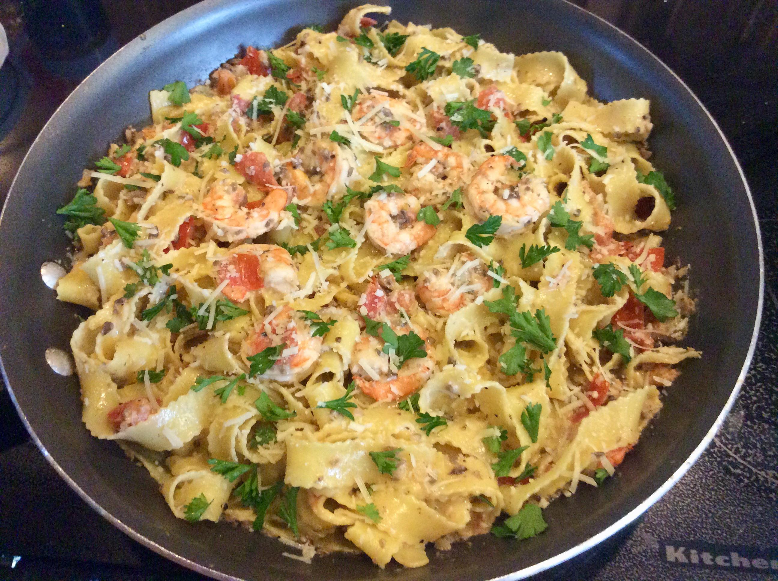 Shrimp pasta tossed in a champagne cream sauce with Roma tomatoes, baby