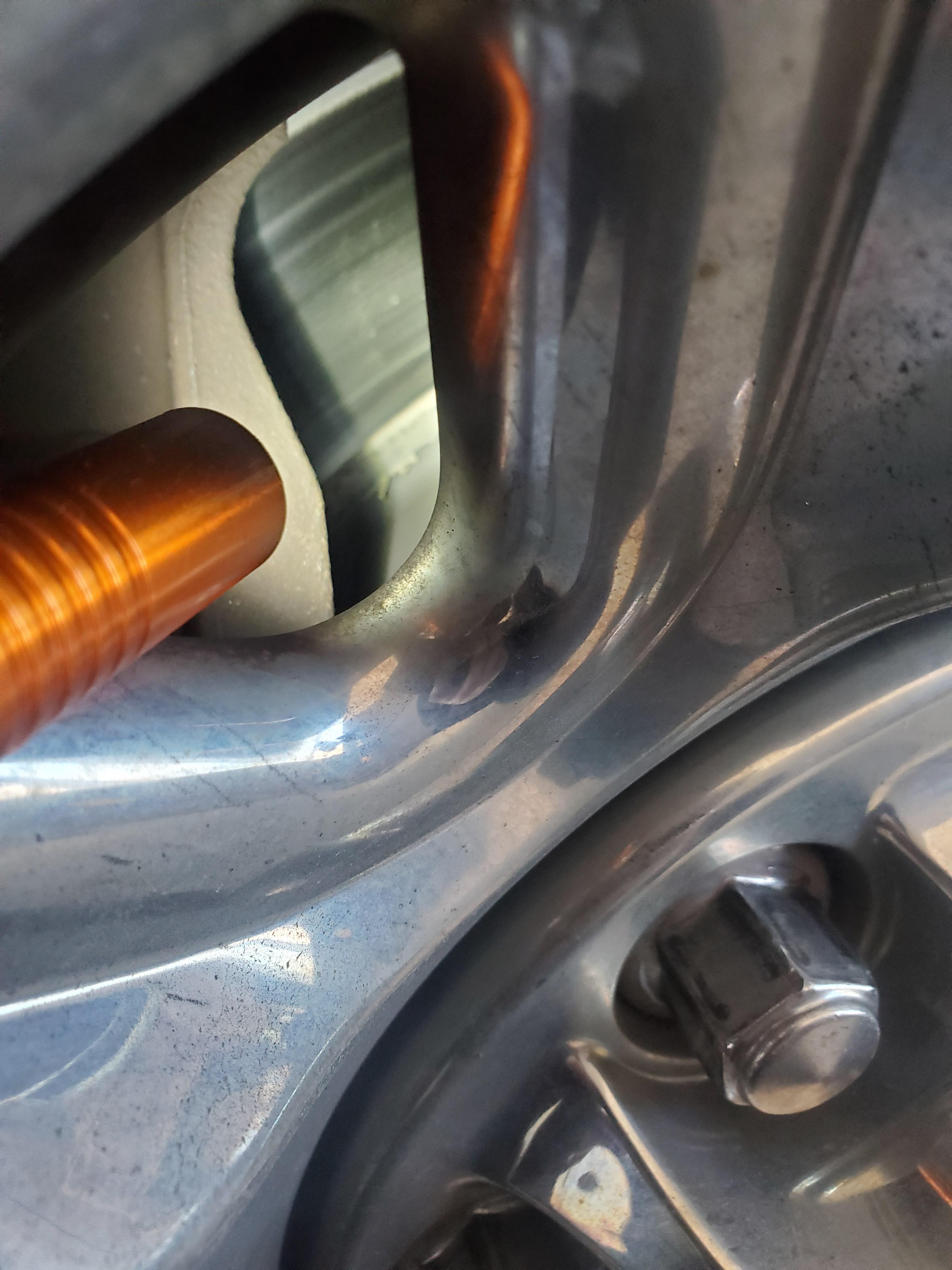 Bad picture, but that's a rotor flaking into ash behind a wheel too hot